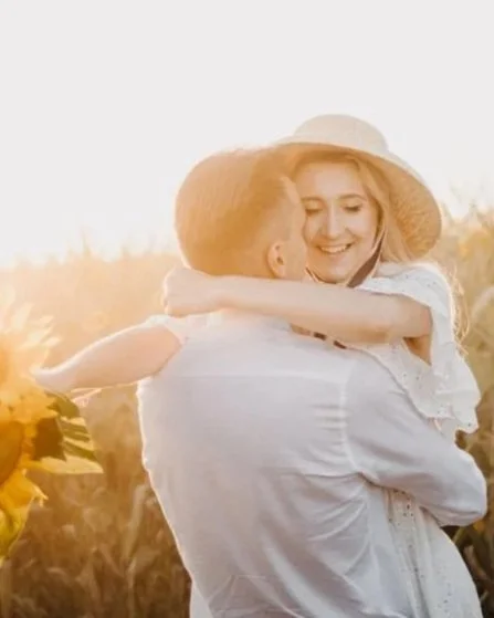A couple hugging in a field of sunflowers