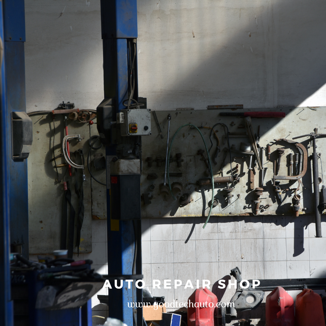 Interior of an auto repair shop with tools hanging on the wall and equipment visible.