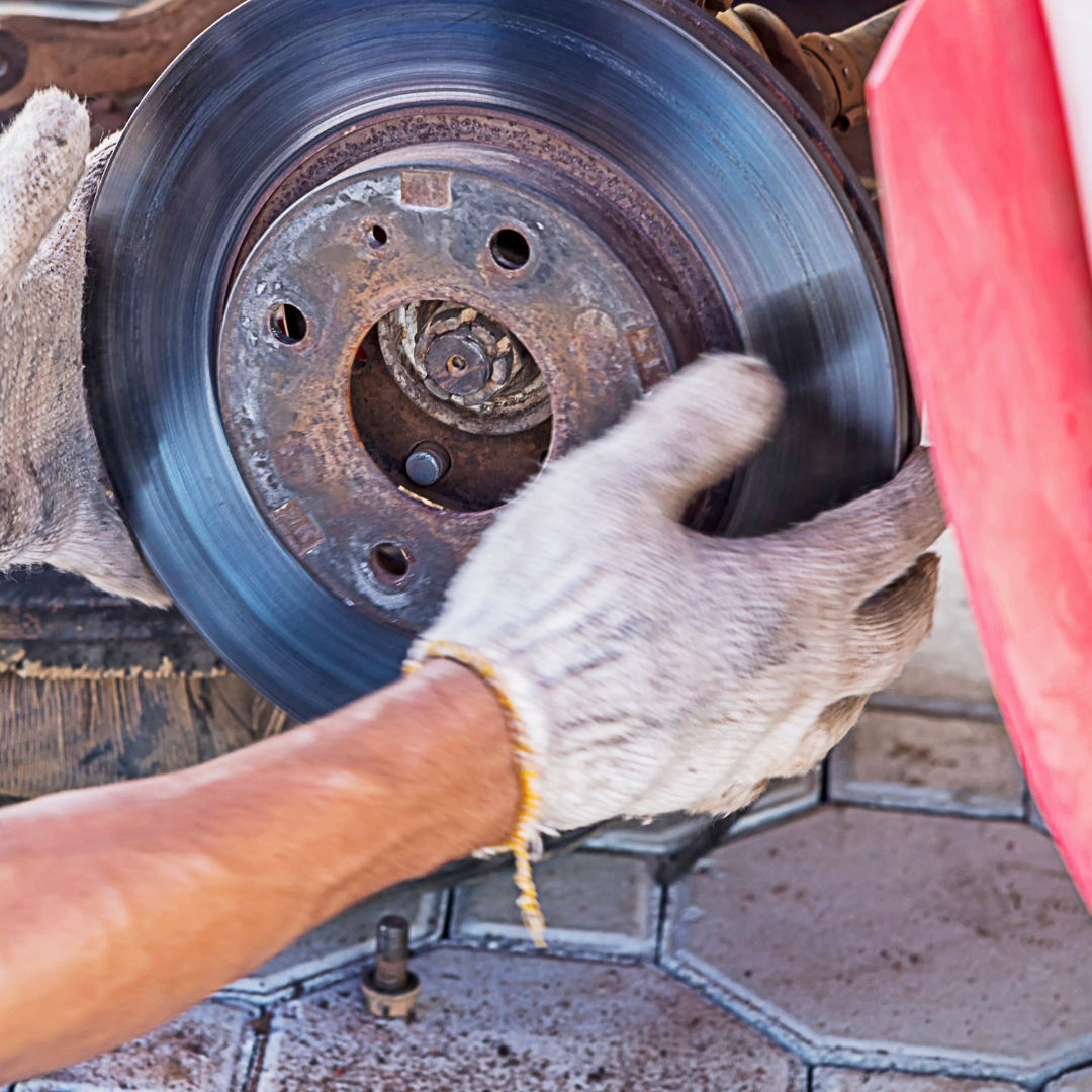 Auto Brakes replacement, mechanic working on the car's brake replacement, new brakes rotos and pads installed