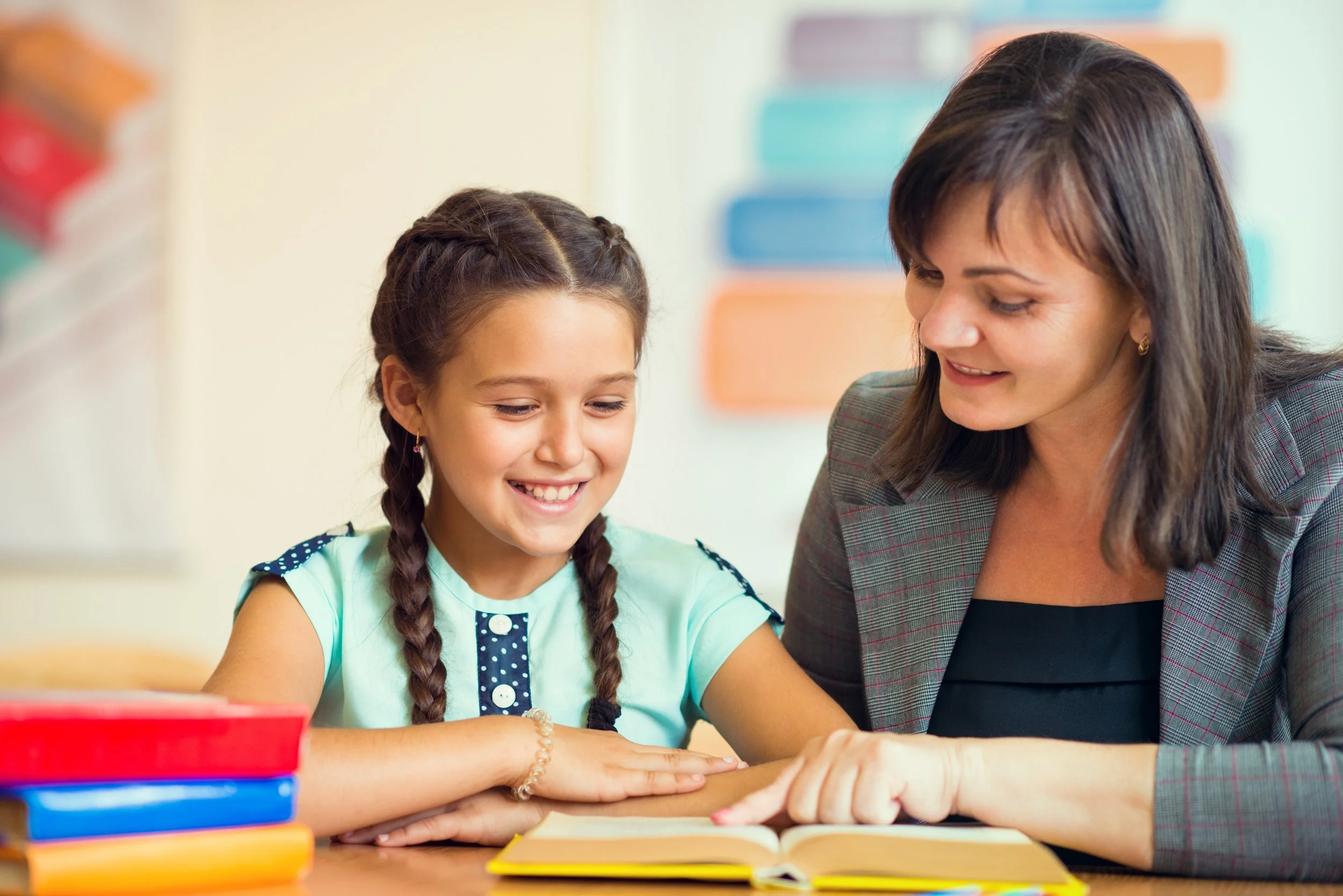 Educator and a young girl are read together