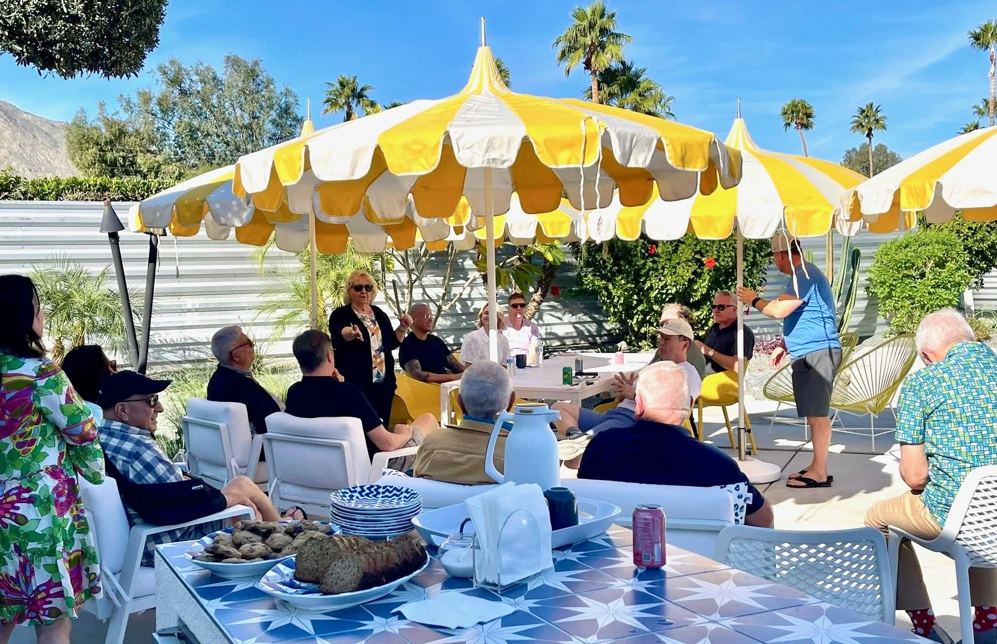 Group of neighbors sitting around the pool for the meeting.