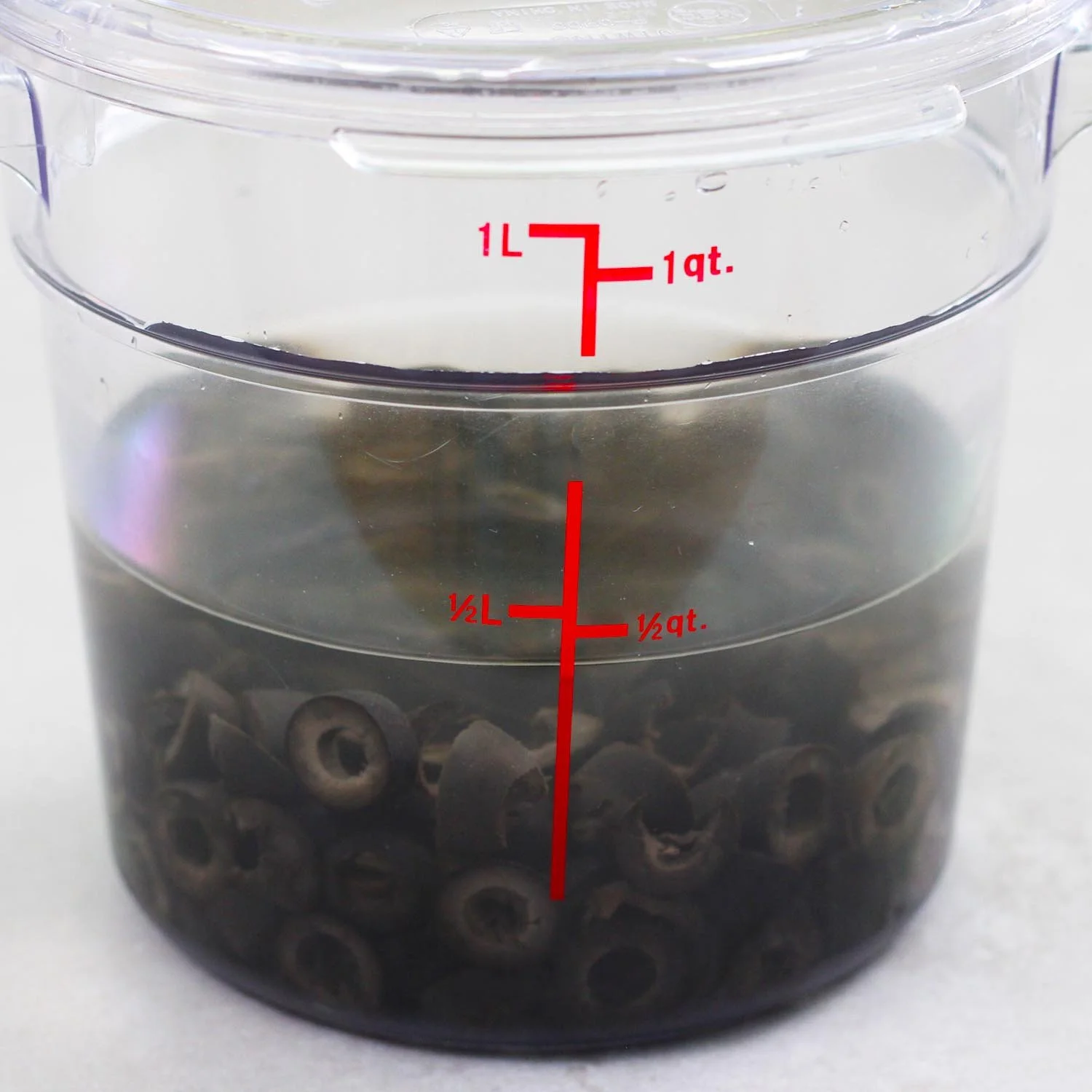 sliced-black-olives-mellowing-in-water-and white-wine-vinegar