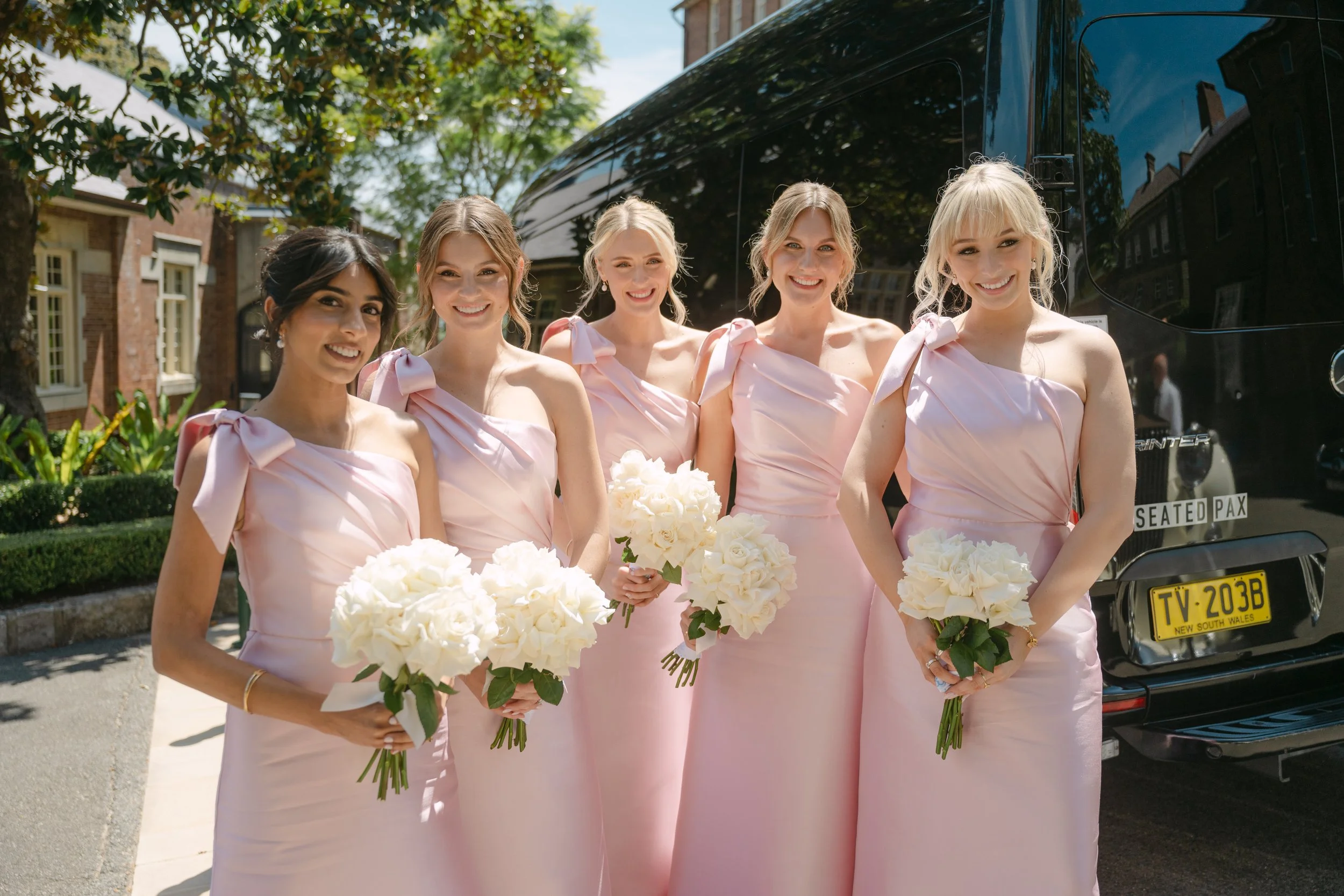 5 custom bridesmaids with one shoulder necklines and bow detailing