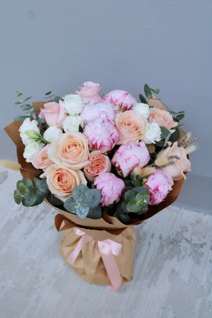 Mixed bouquet of pink and peach flowers with eucalyptus and dried bunny tails