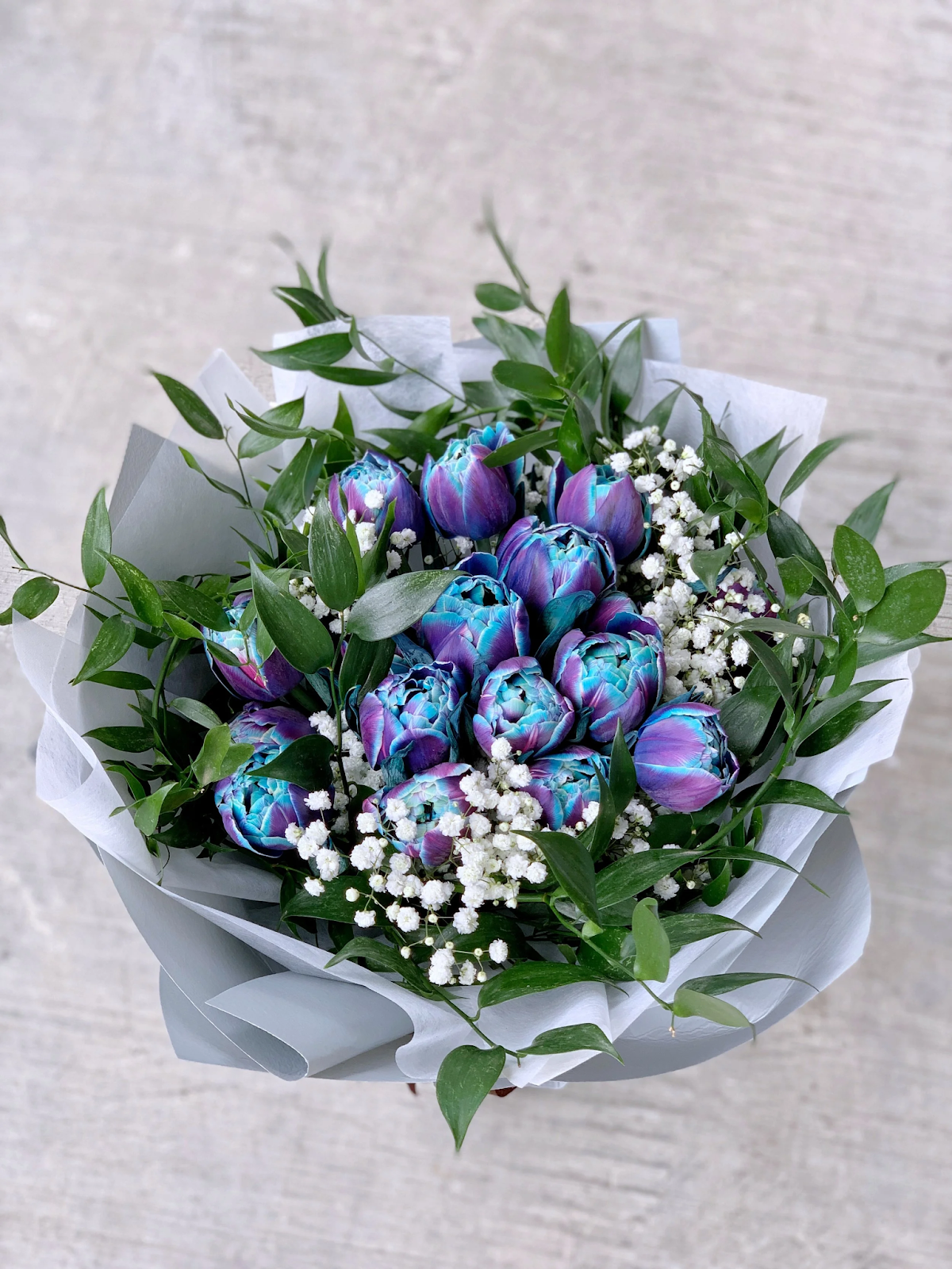 Bouquet of blue and purple tulips mixed with white flowers