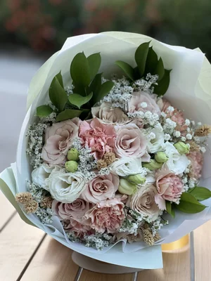 Mixed bouquet of beige roses, pink carnations, and white flowers