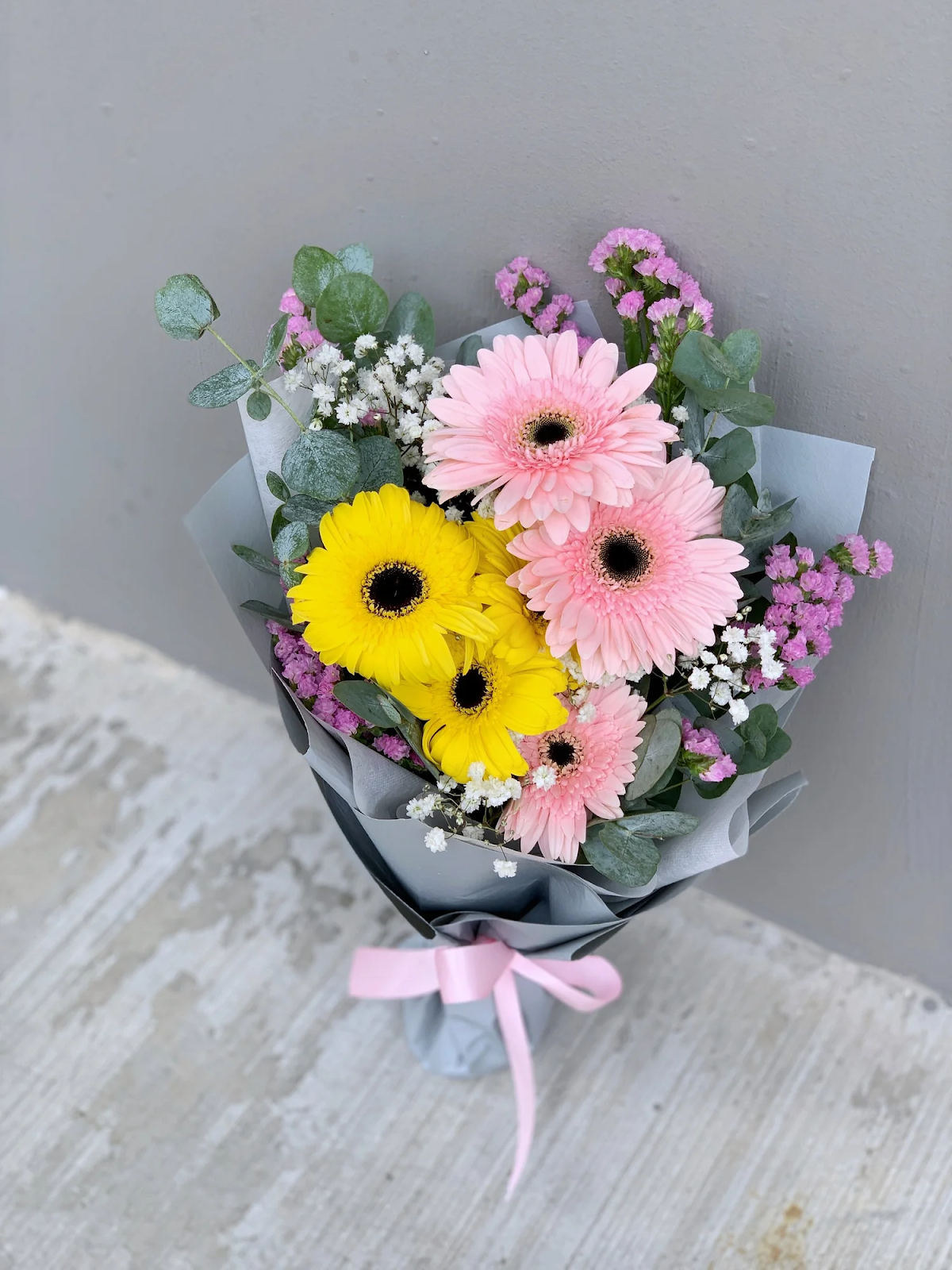A colorful arrangement featuring gerberas, baby's breath, and statice, offering a vibrant alternative to roses when choosing types of flowers for Valentine's Day