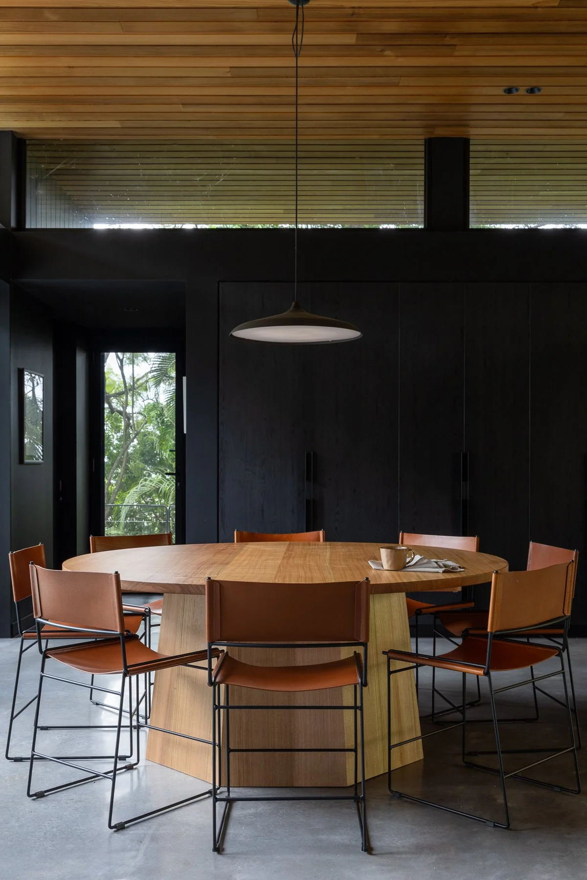 Contemporary oak dining table with leather and black legs