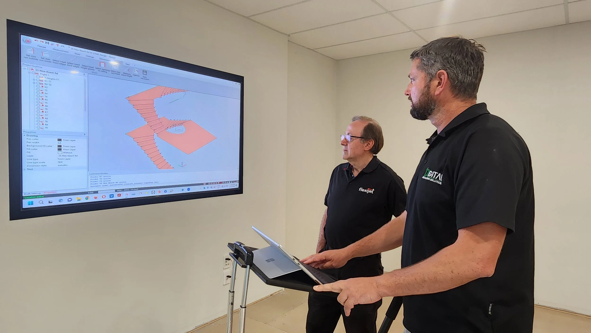 Clive and team reviewing fabrication CAD design on large screen