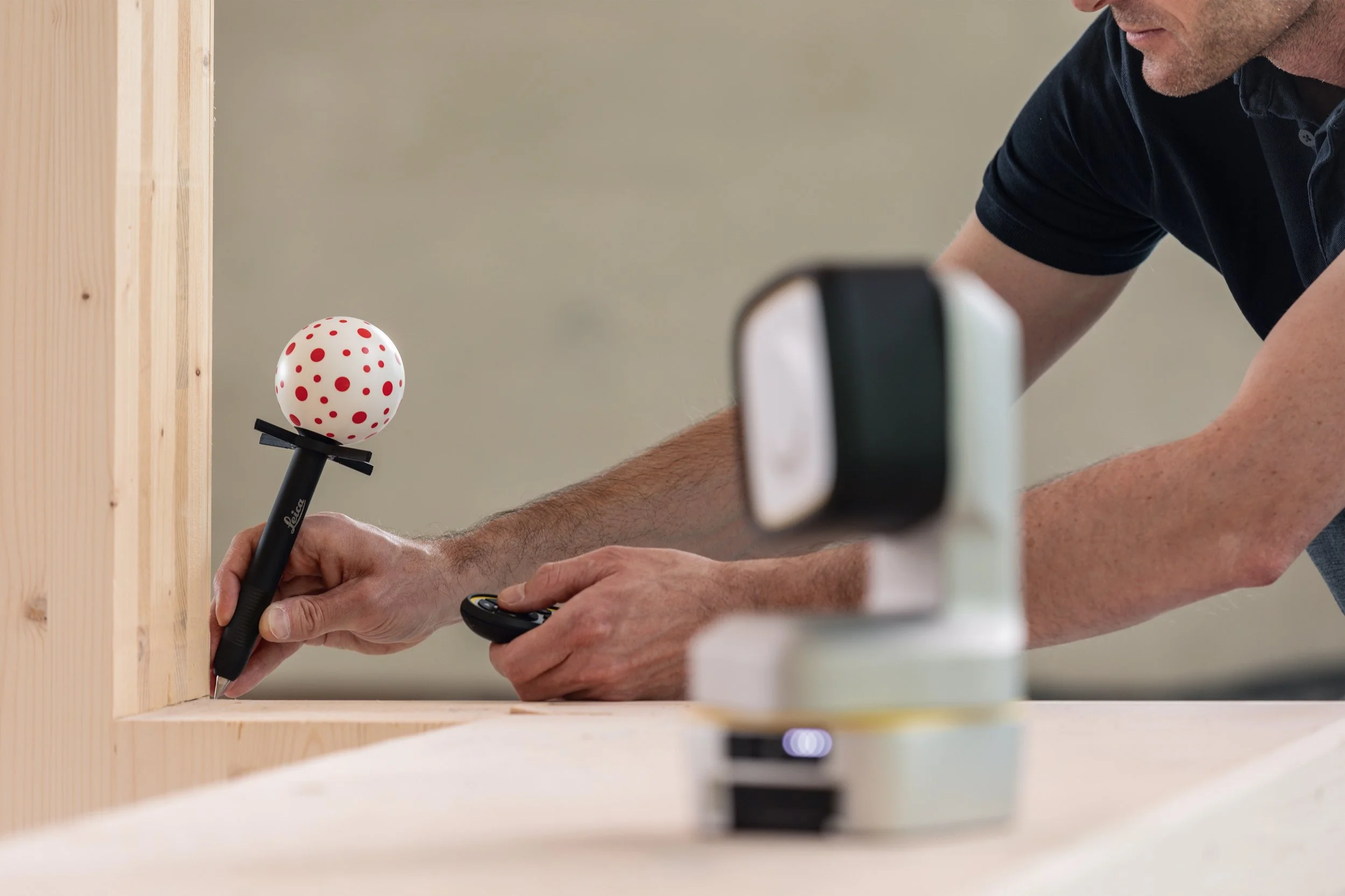 Leica vPen being used to touch-measure a timber surface on site