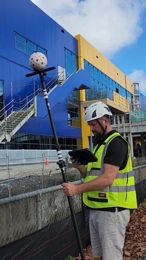 Operator using the Leica iCON iCS50 V-Pole and tablet on the IKEA Sylvia Park construction site, Auckland