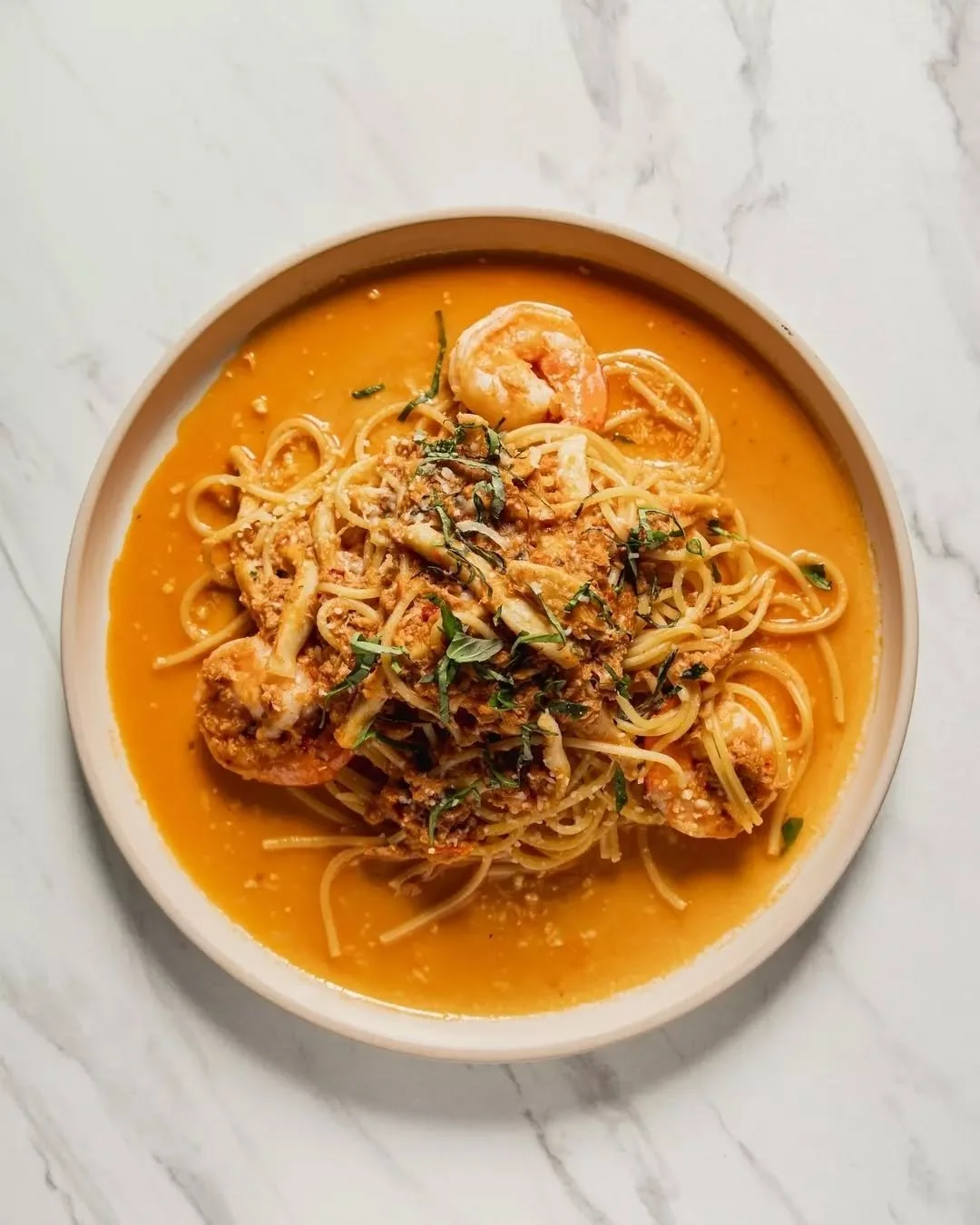 A generous plate of the sea, brought together with balance and intent.

Spaghetti layered with king prawns, tender squid, crab meat and tuna, lifted with white wine and a rich napolitana sauce, then finished with parmesan for a savoury, lingering dep