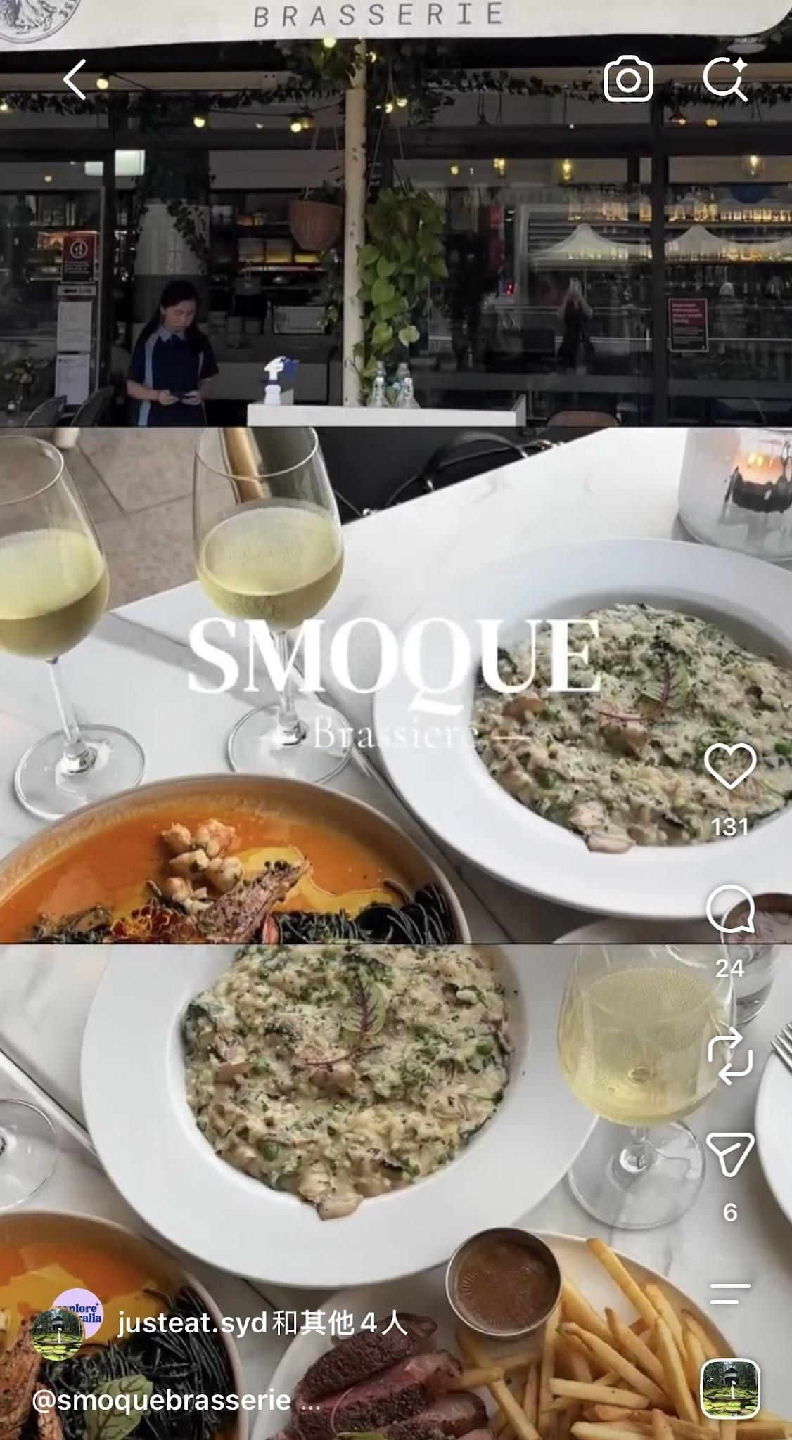 Outdoor restaurant scene with a view of the inside through large glass windows, a waitress standing near a table, two glasses of white wine, and two dishes of pasta and salad with fries and steak on a white table.