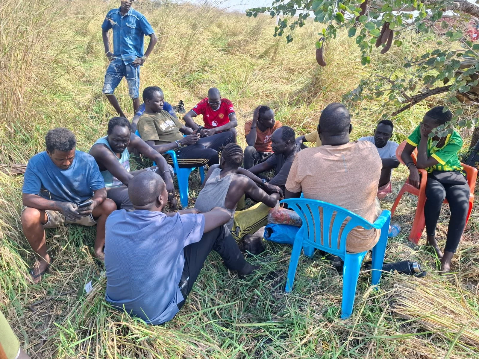 'Mixed nationalities frustrated under a small tree'