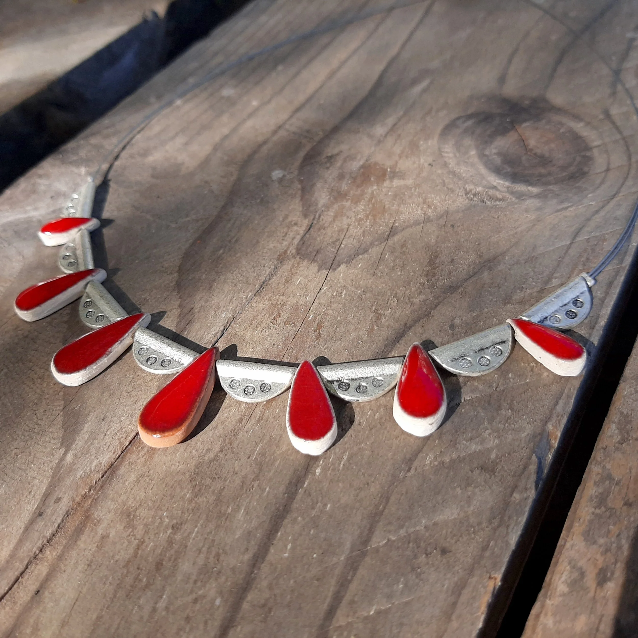 Handmade drop ceramic necklace, dark red on white clay
