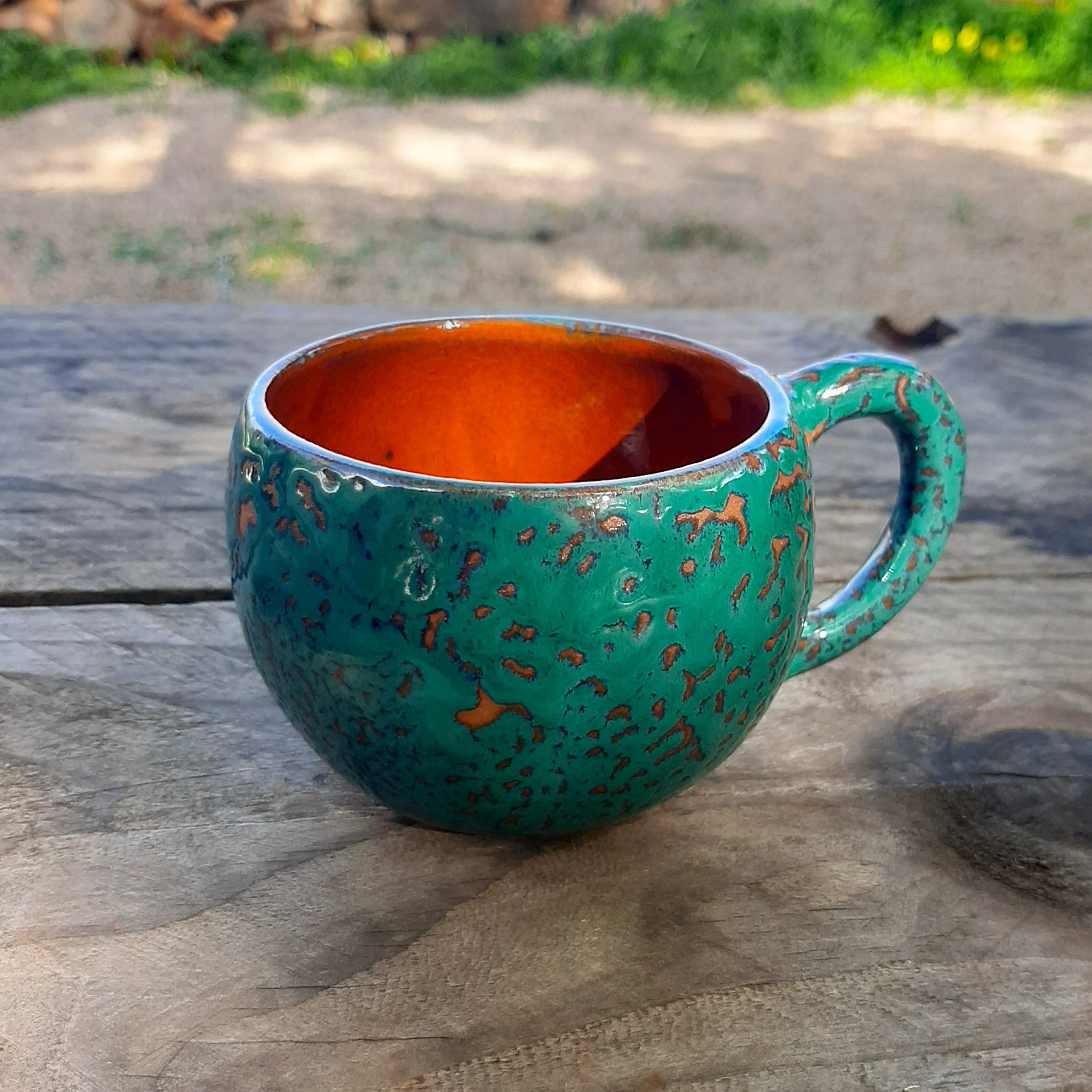 Round ceramic coffee cup, ocean green and orange papaya