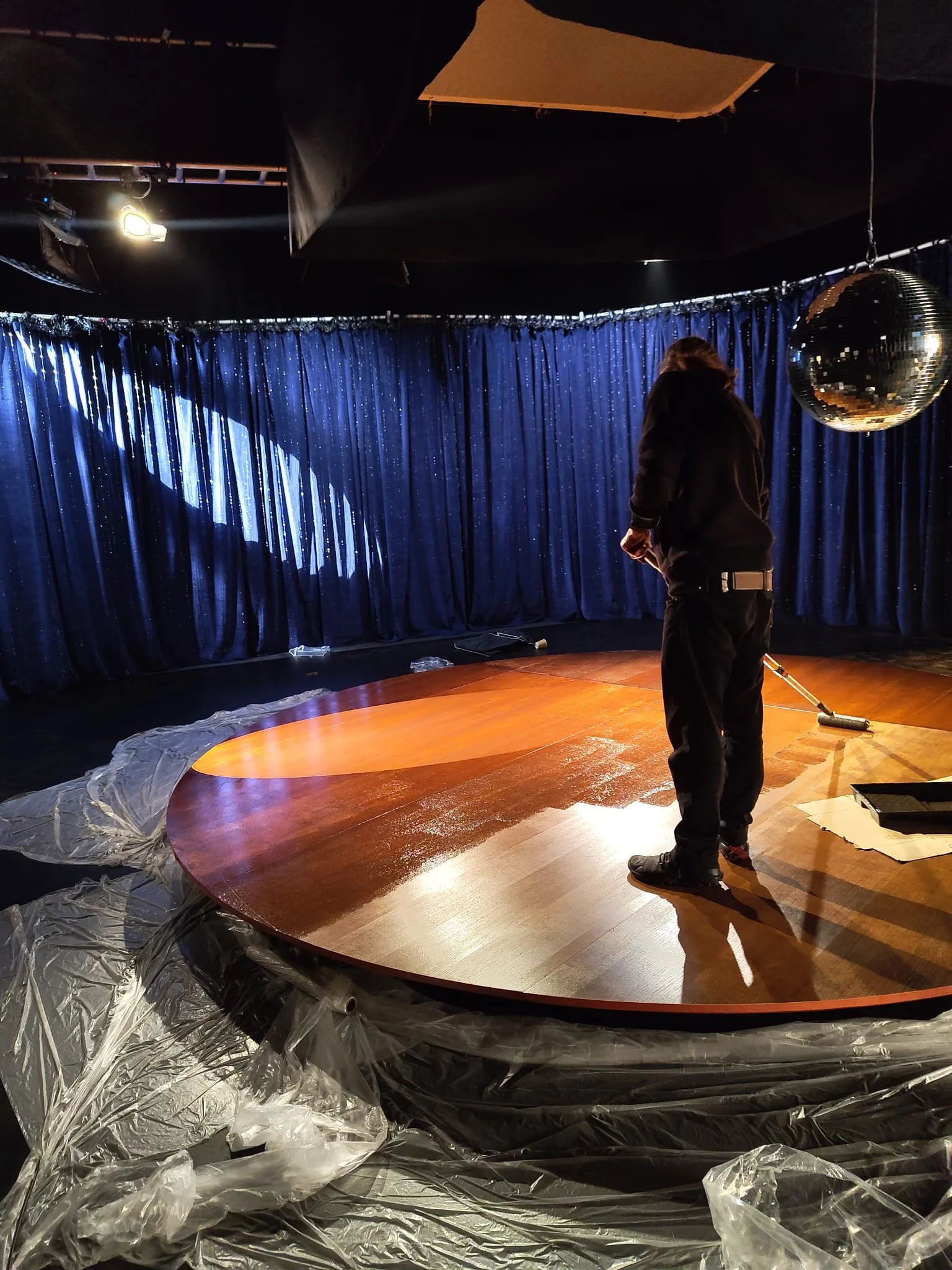 Our set builder varnishing our stage set build for DHS x Jonathan Ross ident