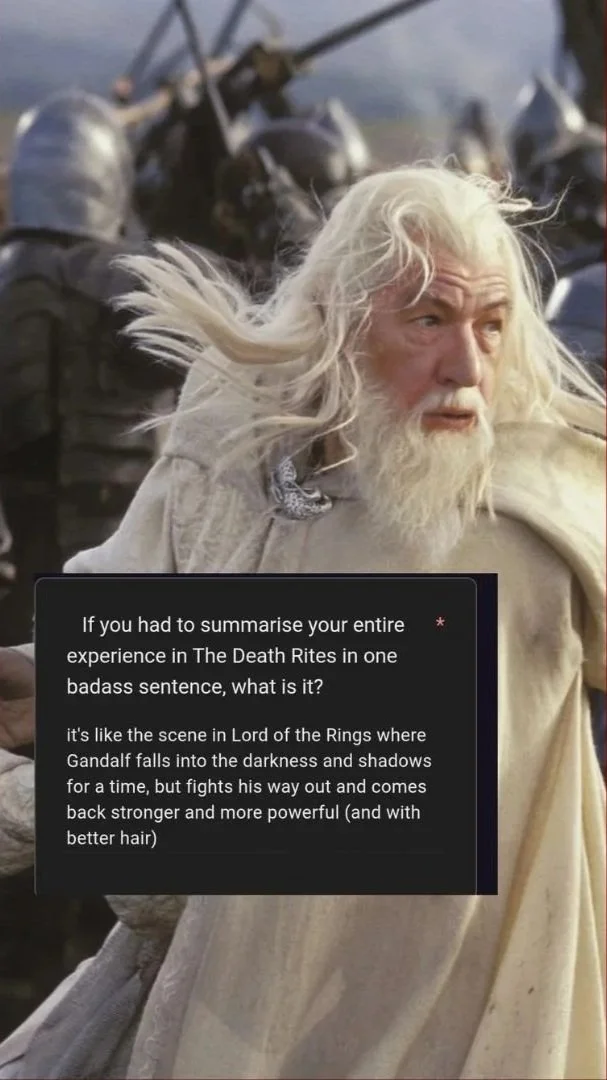 A scene from Lord of the Rings showing Gandalf, an elderly man with long white hair and beard, wearing a light-colored robe, with a background of armored soldiers and a battlefield.