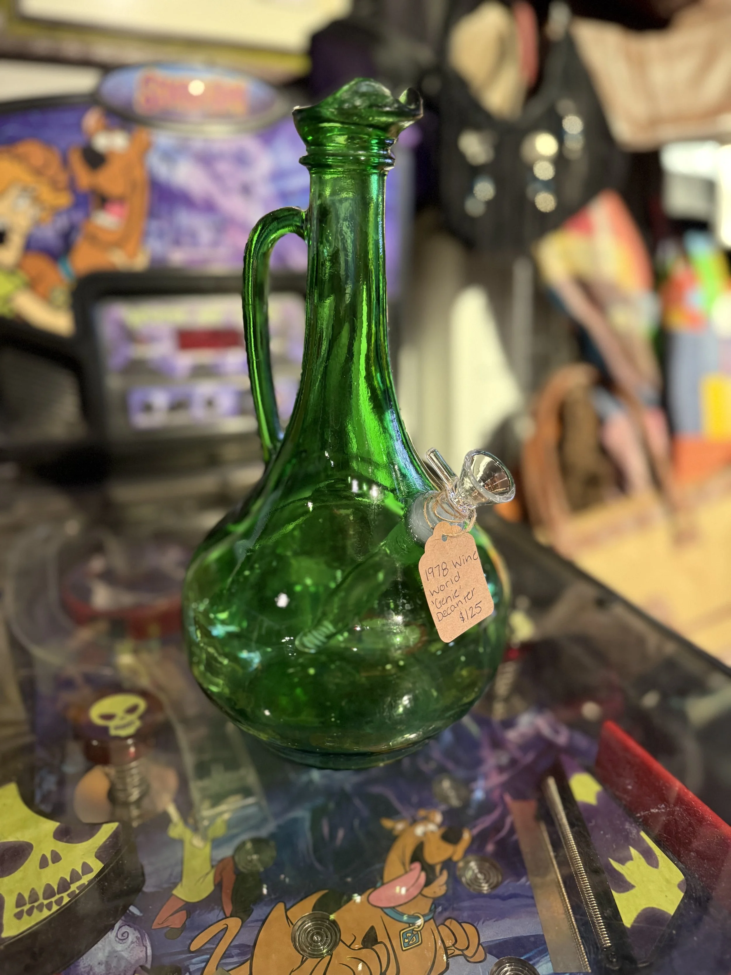 Image of a vintage green decanter that is a 1978 Wine World "Genie" Decanter that has been changed into a bong from Retro Smoke Co.
