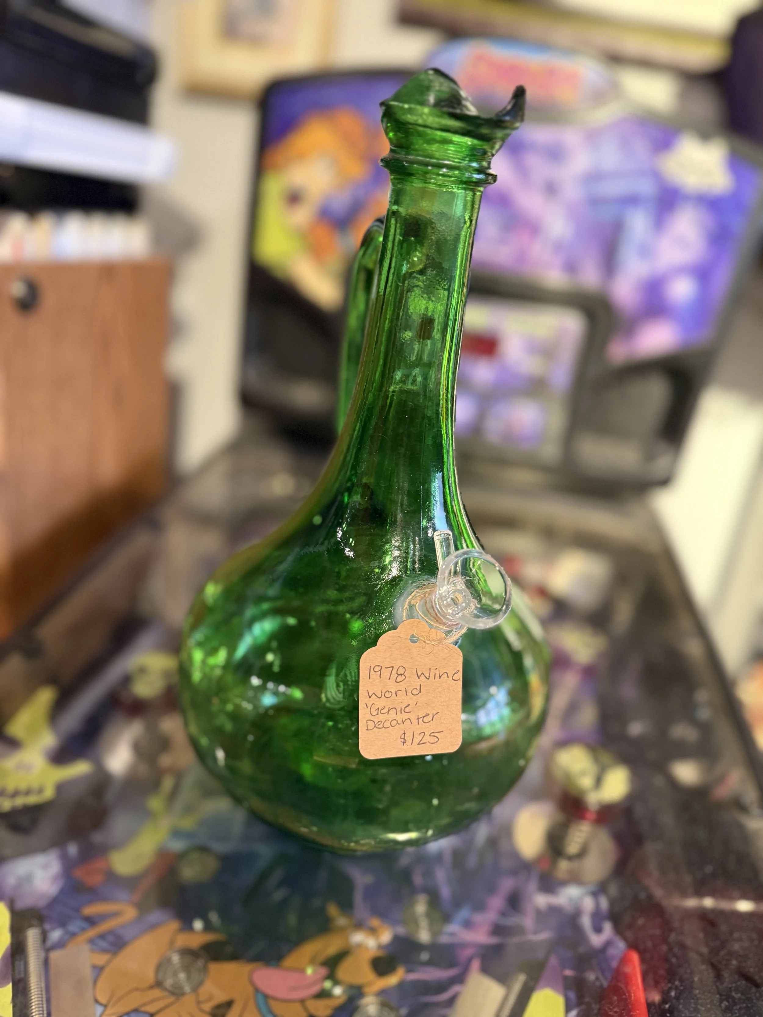 Image of a vintage green decanter that is a 1978 Wine World "Genie" Decanter that has been changed into a bong from Retro Smoke Co. from a front angle.