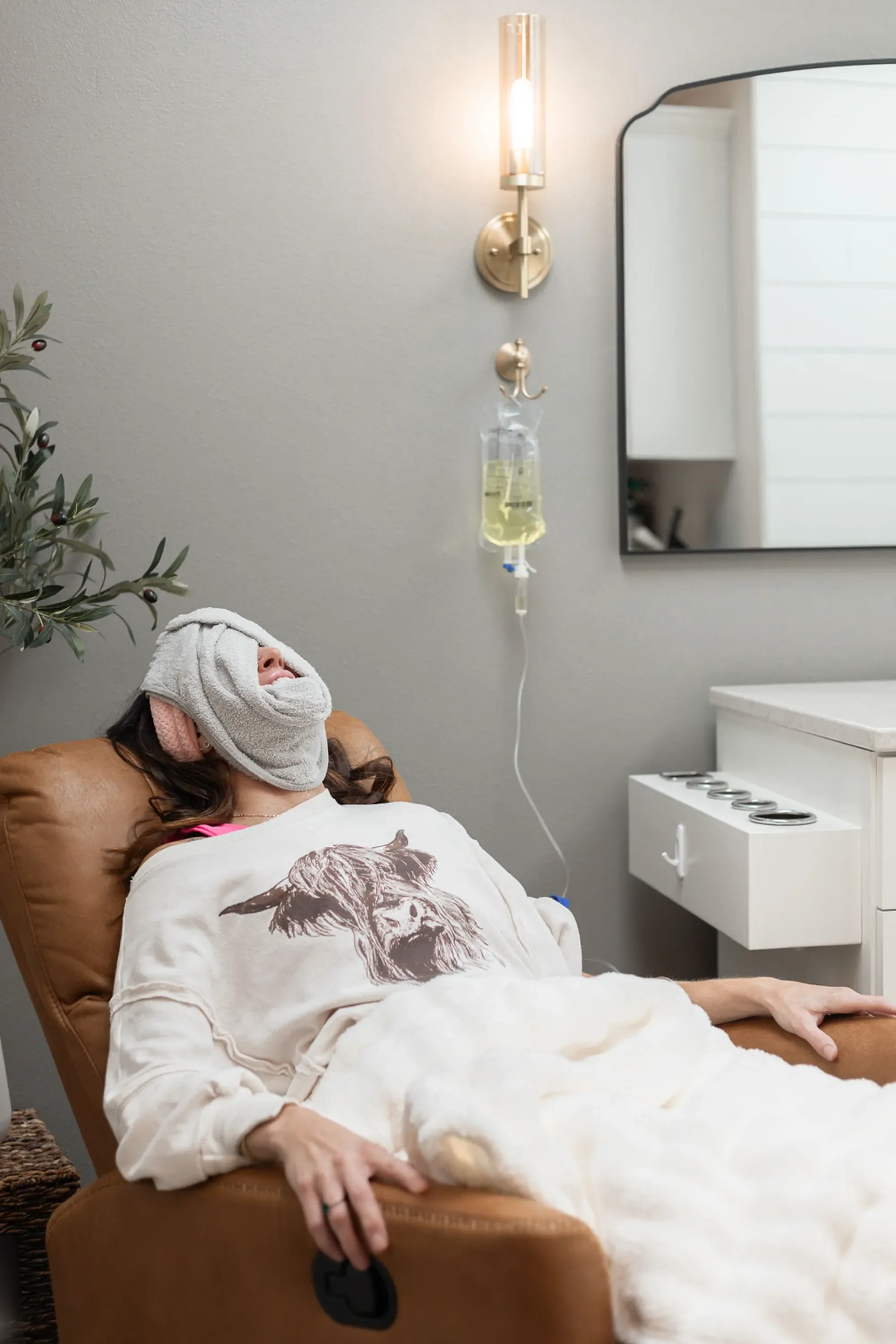 Client relaxing during IV therapy session at Harmony Wellness in Eau Claire