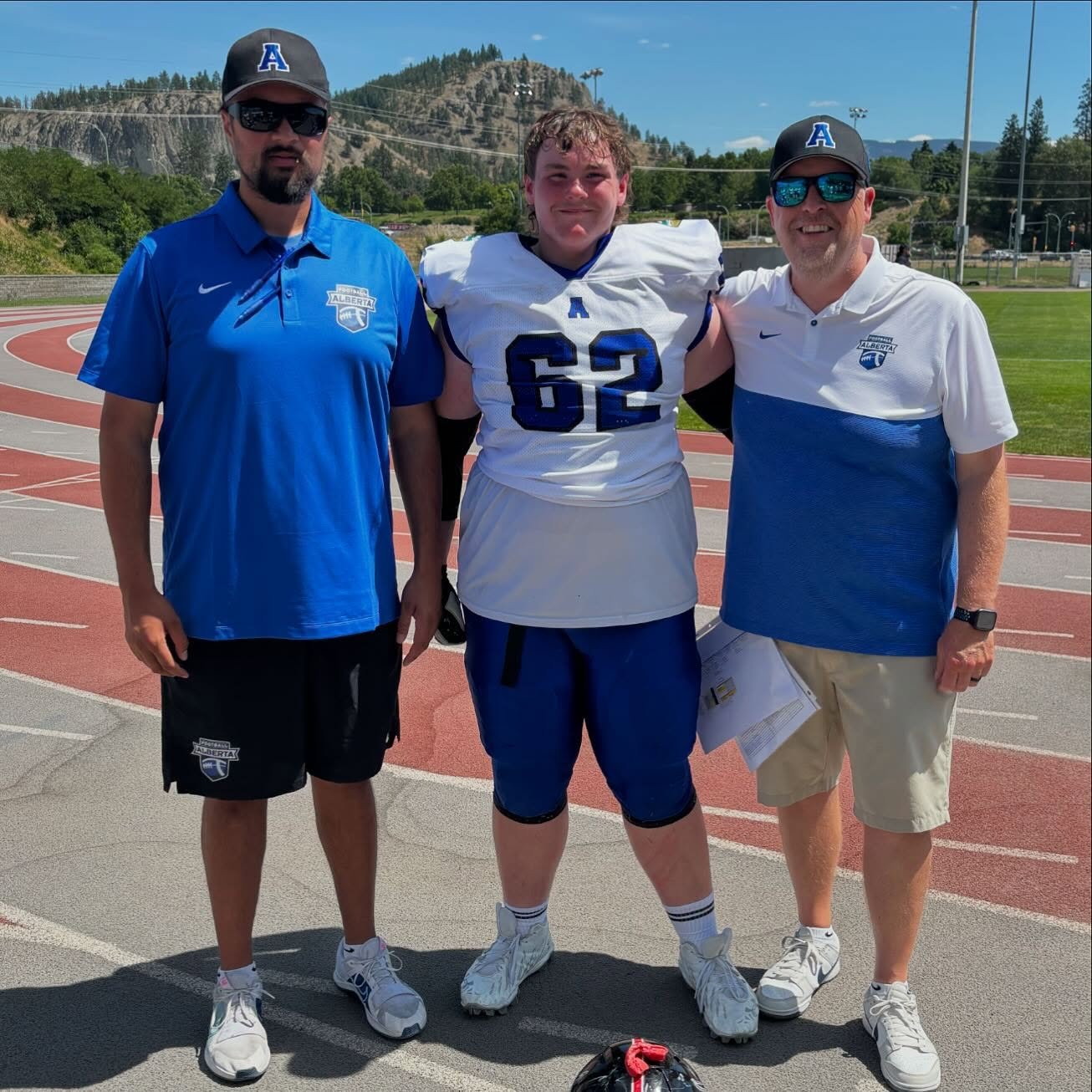 All smiles after a @football.alberta U17 win at the U17 Western Showcase. Representing SAL is Offensive Lineman @samboudreau.fb, Junior Head Coach (OL Coach) Adam Cooper, and Senior Head Coach (RB Coach) Cam Fraser. #PlantTheSword