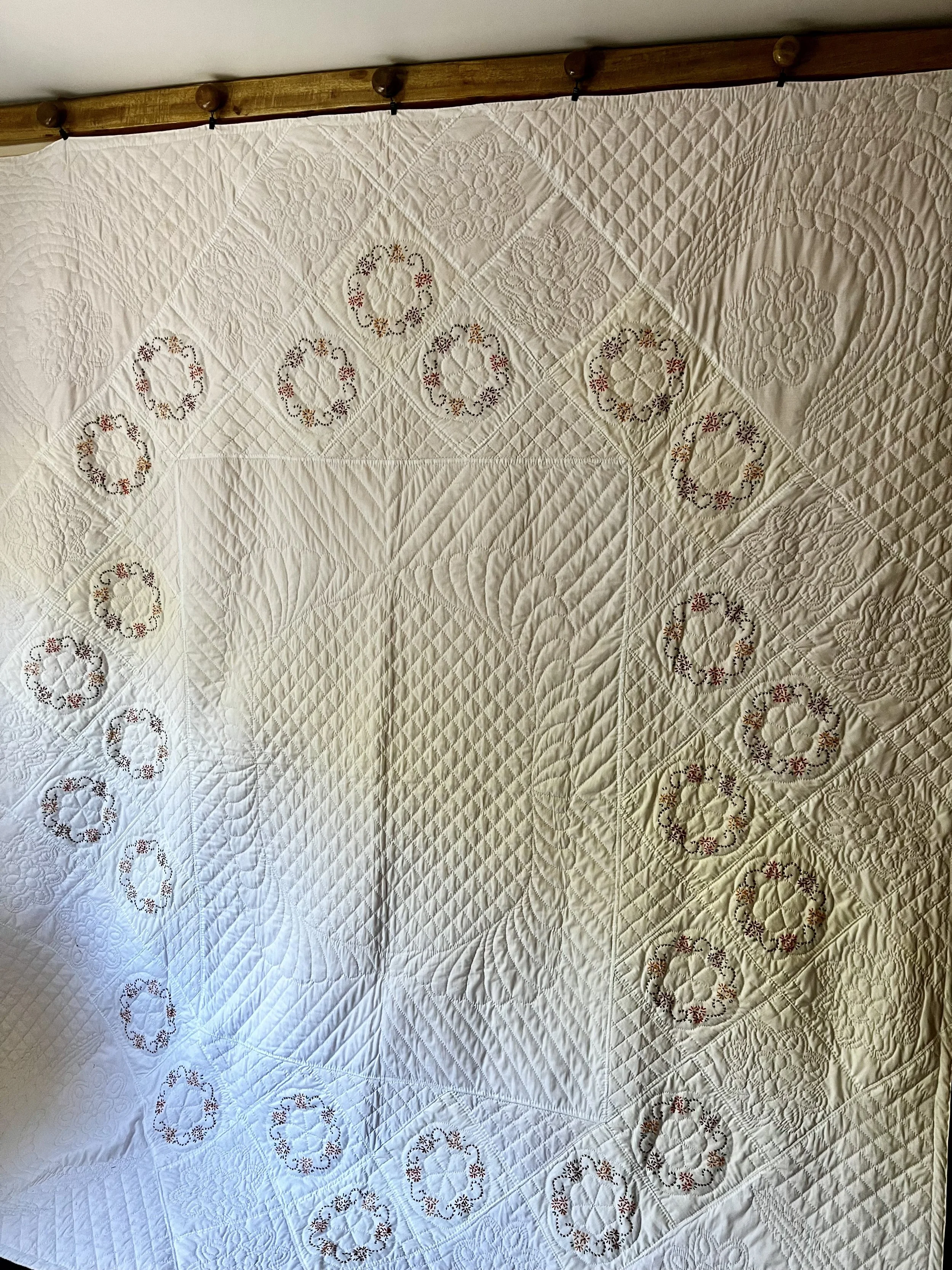 Vintage hand-quilted and hand-embroidered quilt