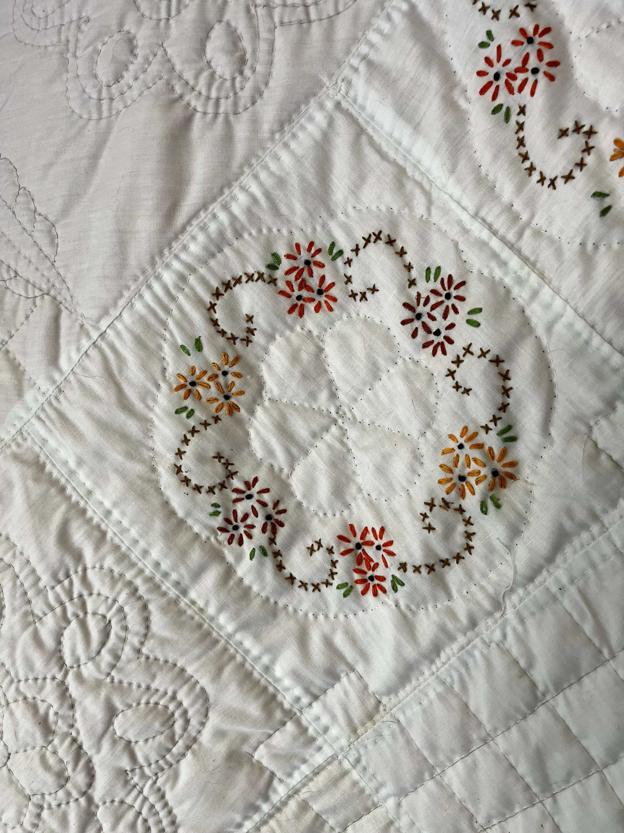 Vintage hand-quilted and hand-embroidered quilt
