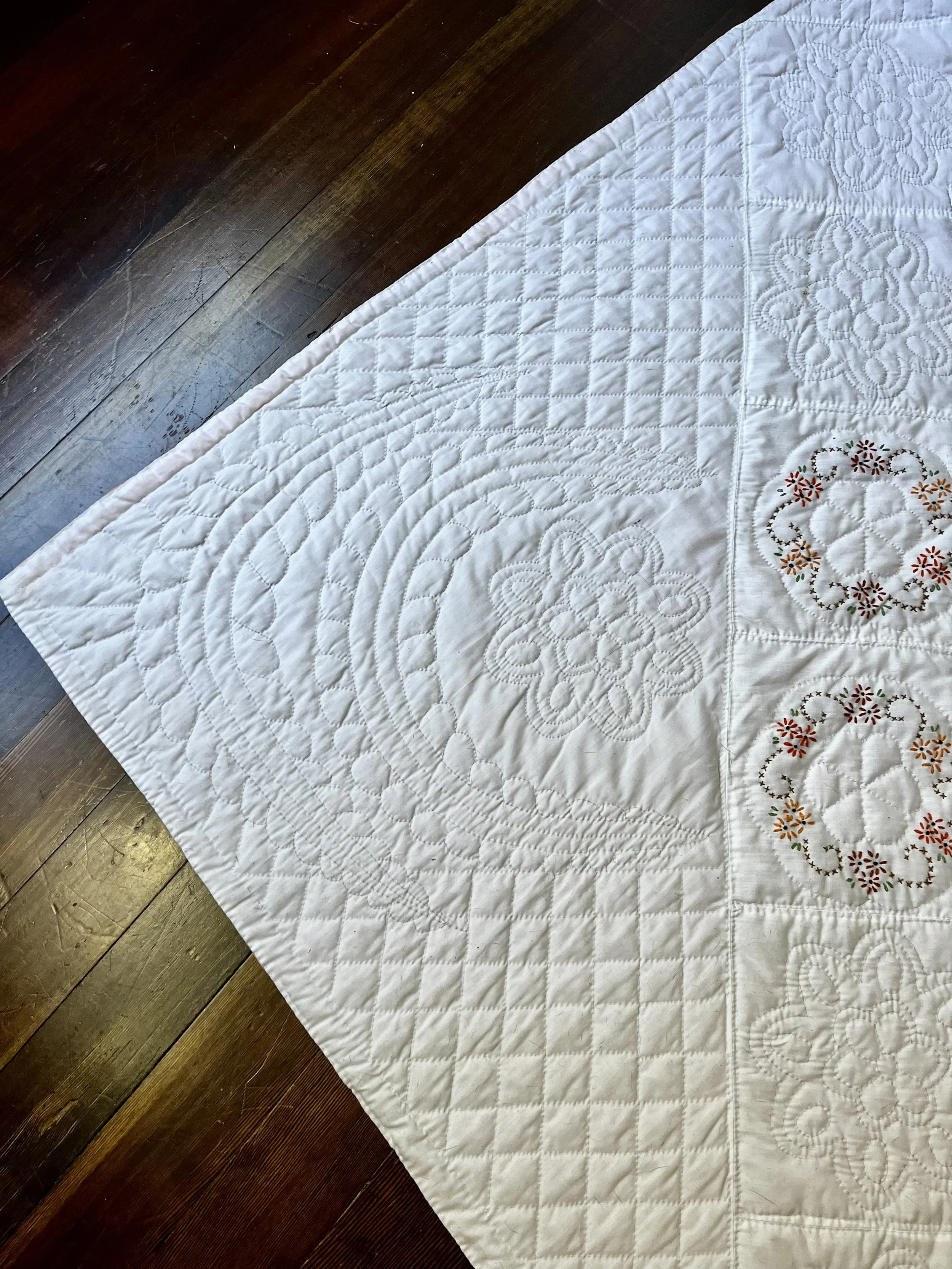 Vintage hand-quilted and hand-embroidered quilt