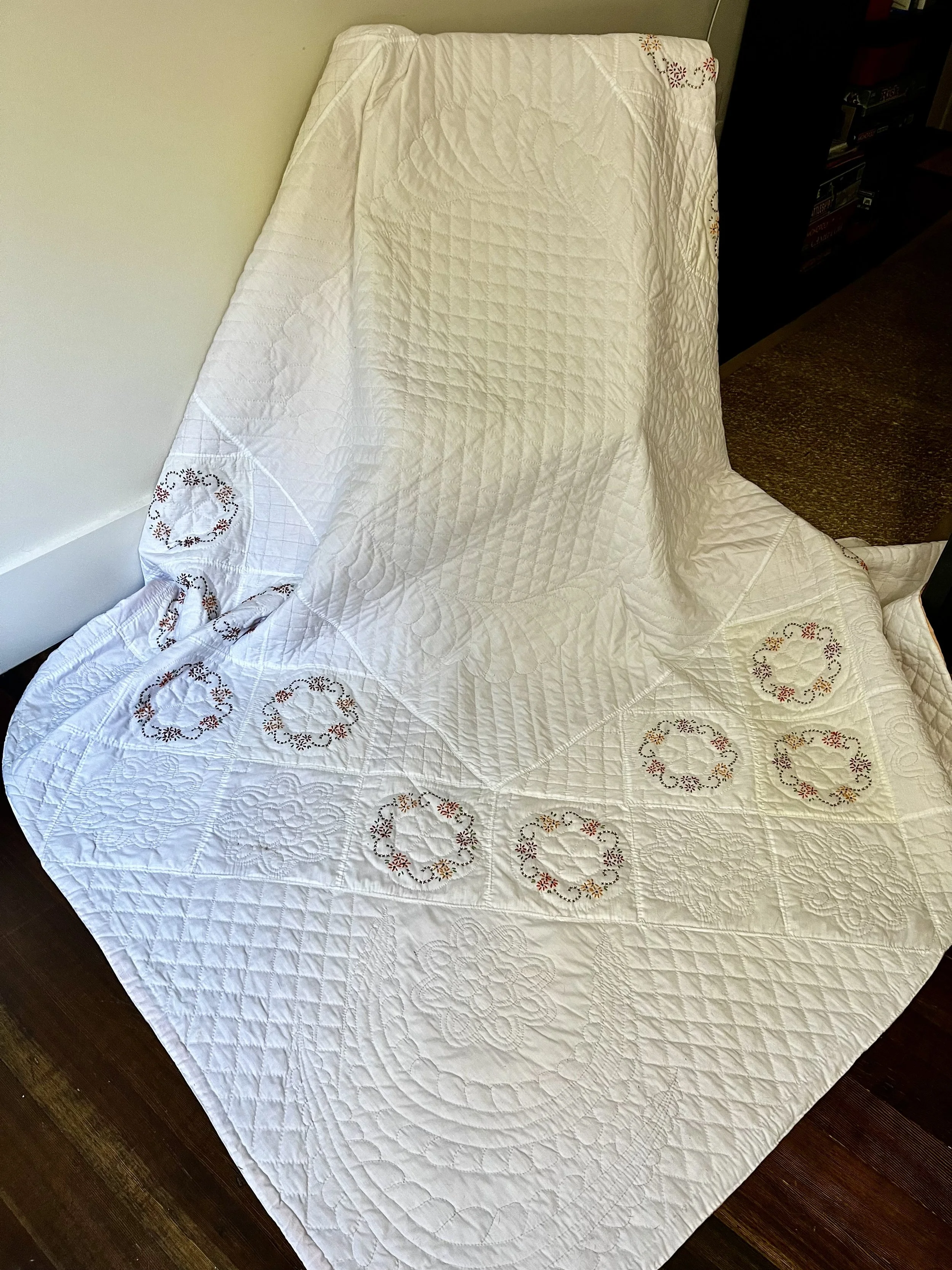Vintage hand-quilted and hand-embroidered quilt
