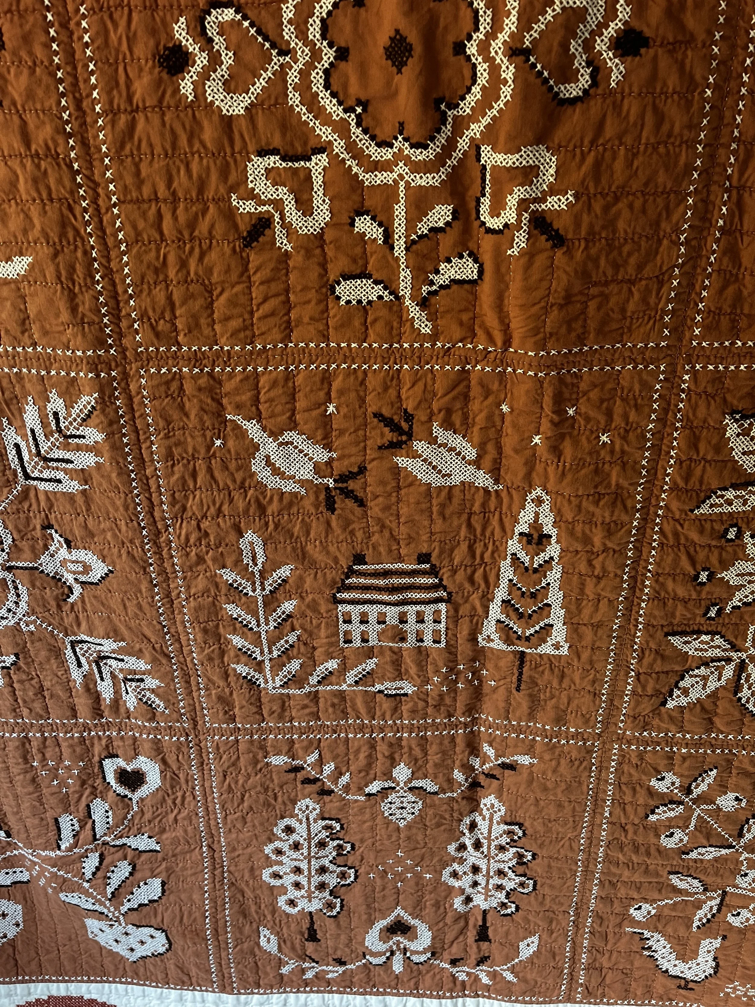 Vintage hand embroidered folk art quilt