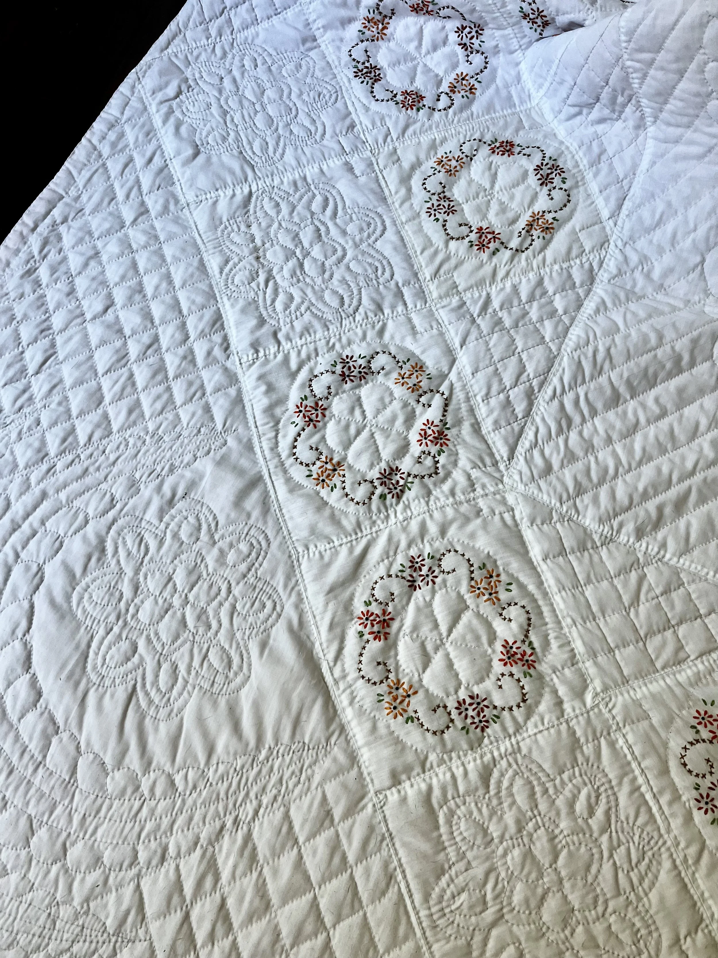 Vintage hand-quilted and hand-embroidered quilt