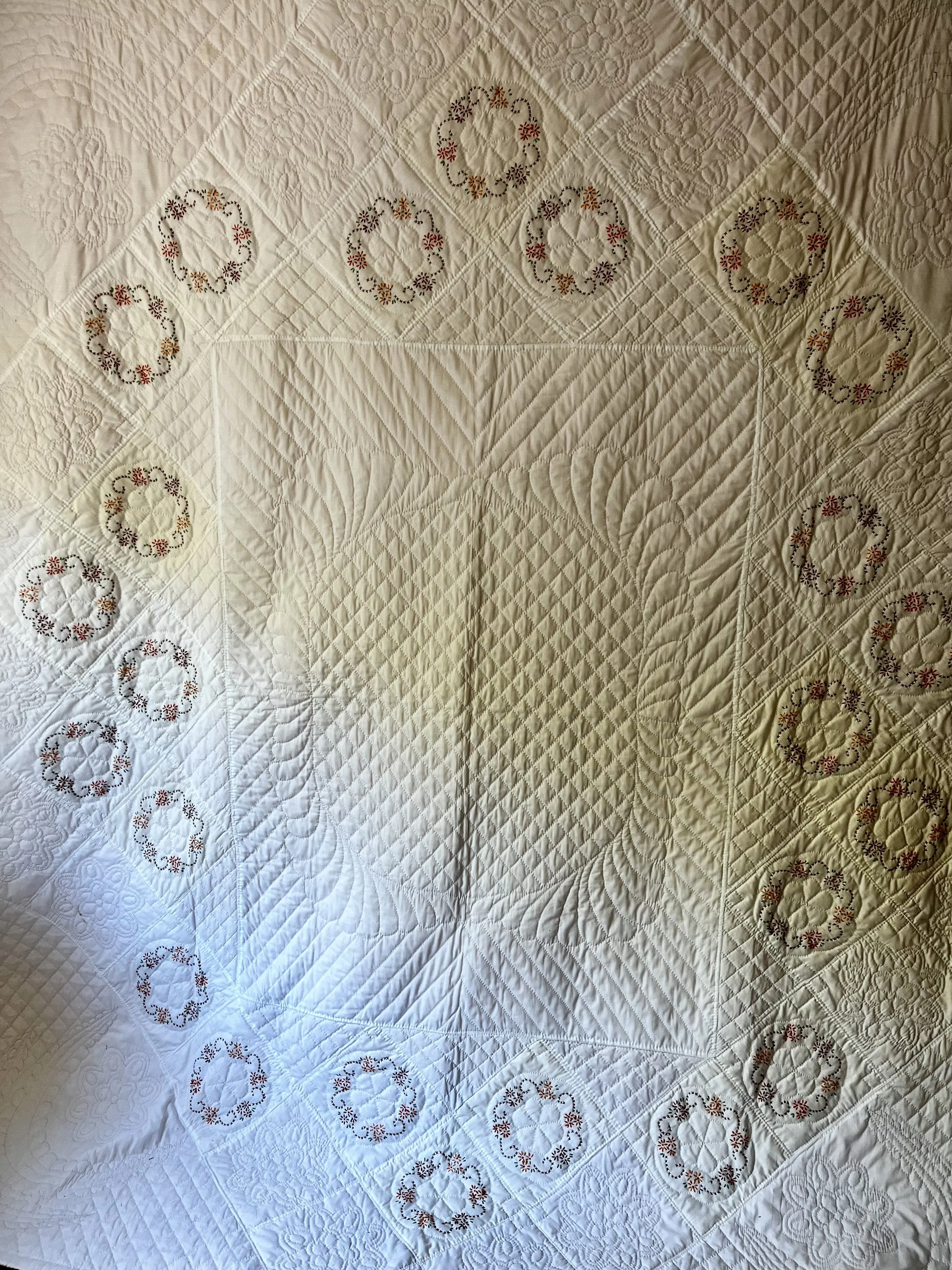 Vintage hand-quilted and hand-embroidered quilt