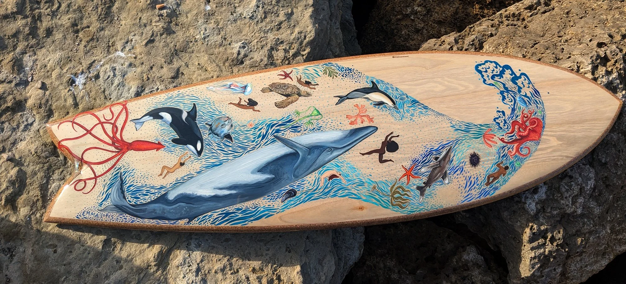 Made by Malua from fast growing paulownia wood grown in Spain with Portuguese cork rails. A far more sustainable way to make surfboards than traditional polyurethane boards which use highly toxic materials. Emma painted marine wildlife that can be se