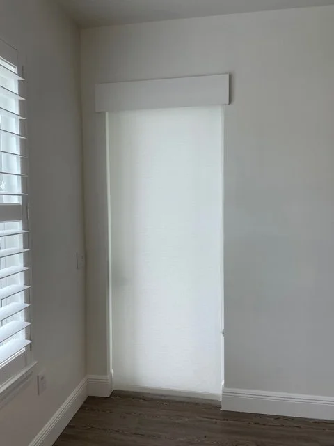 Rollershade over door with simple wood valance.jpg
