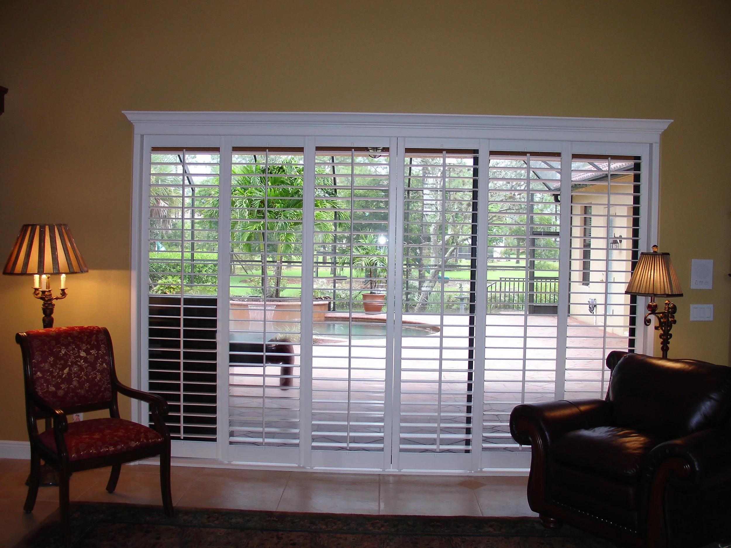 Center tilt rod ISMT Sliding Shutter, Box with Crown, panels stack on glass.jpg