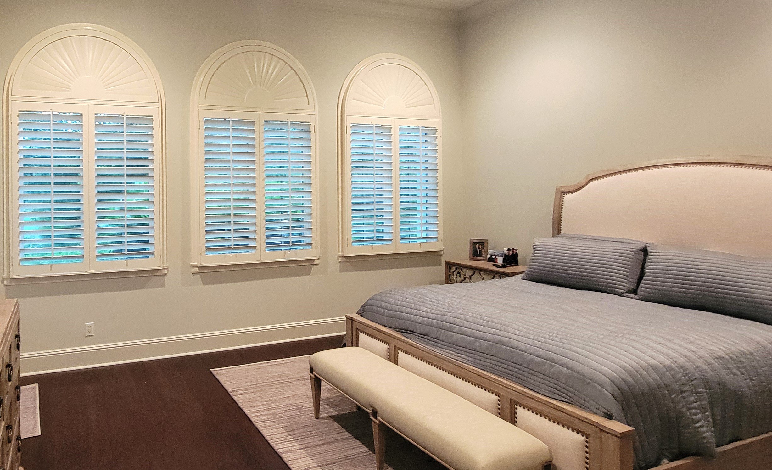 Center tilt rod shutters with sunburst arches.jpg