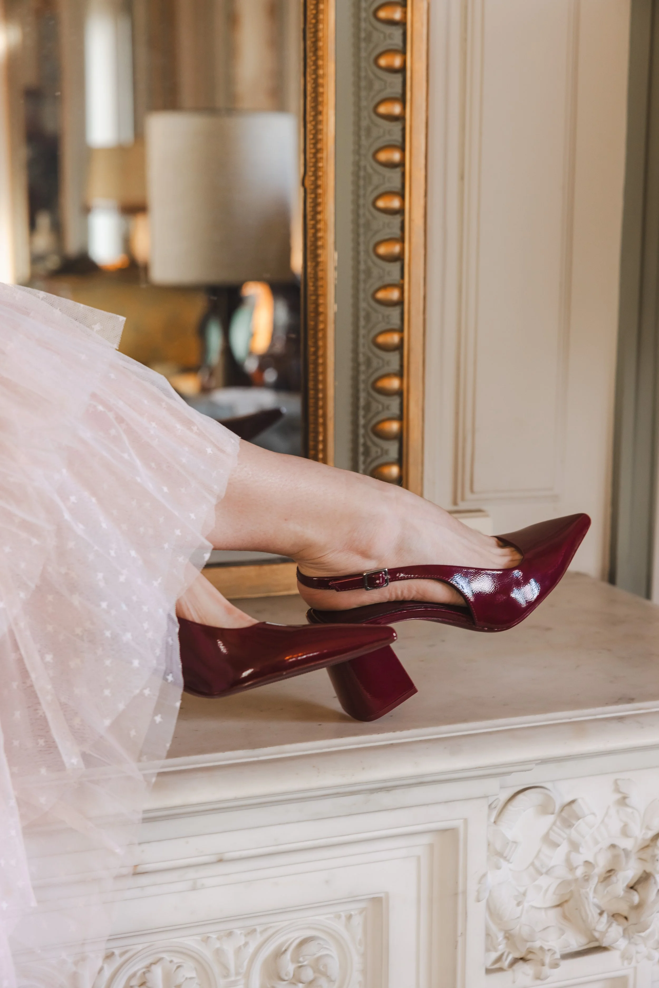 Focus sur les escarpins portés par une mannequin dans un château
