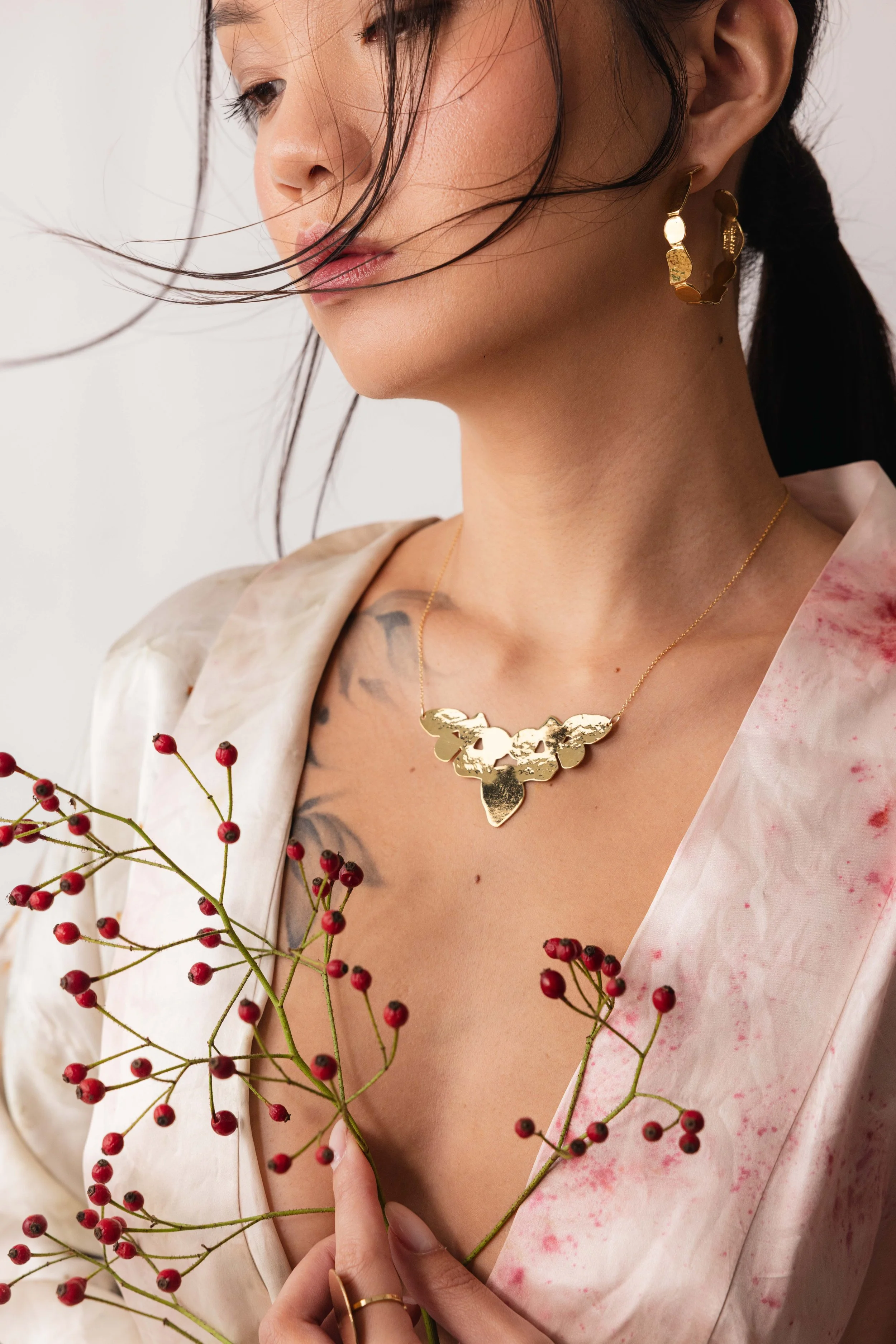 Portrait d'une mannequin en kimono portant une parure de bijoux en or