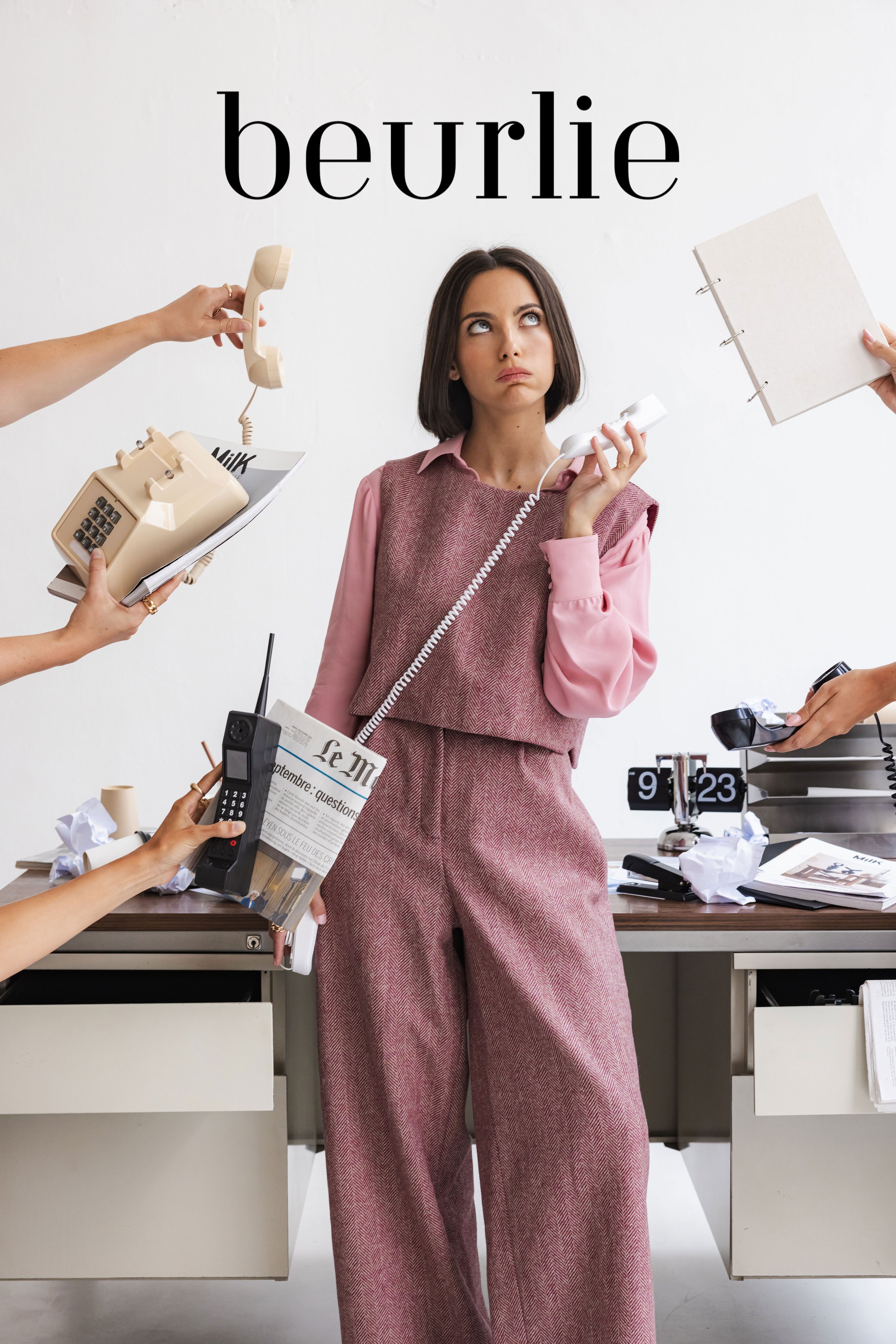 Mannequin en studio en tenue rose devant un bureau