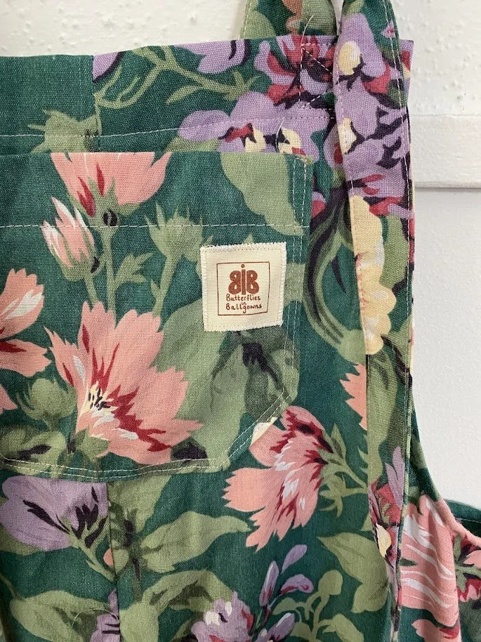 close up of butterflies in ballgowns logo, sewn onto a pair of dungarees made from a thrifted bed sheet