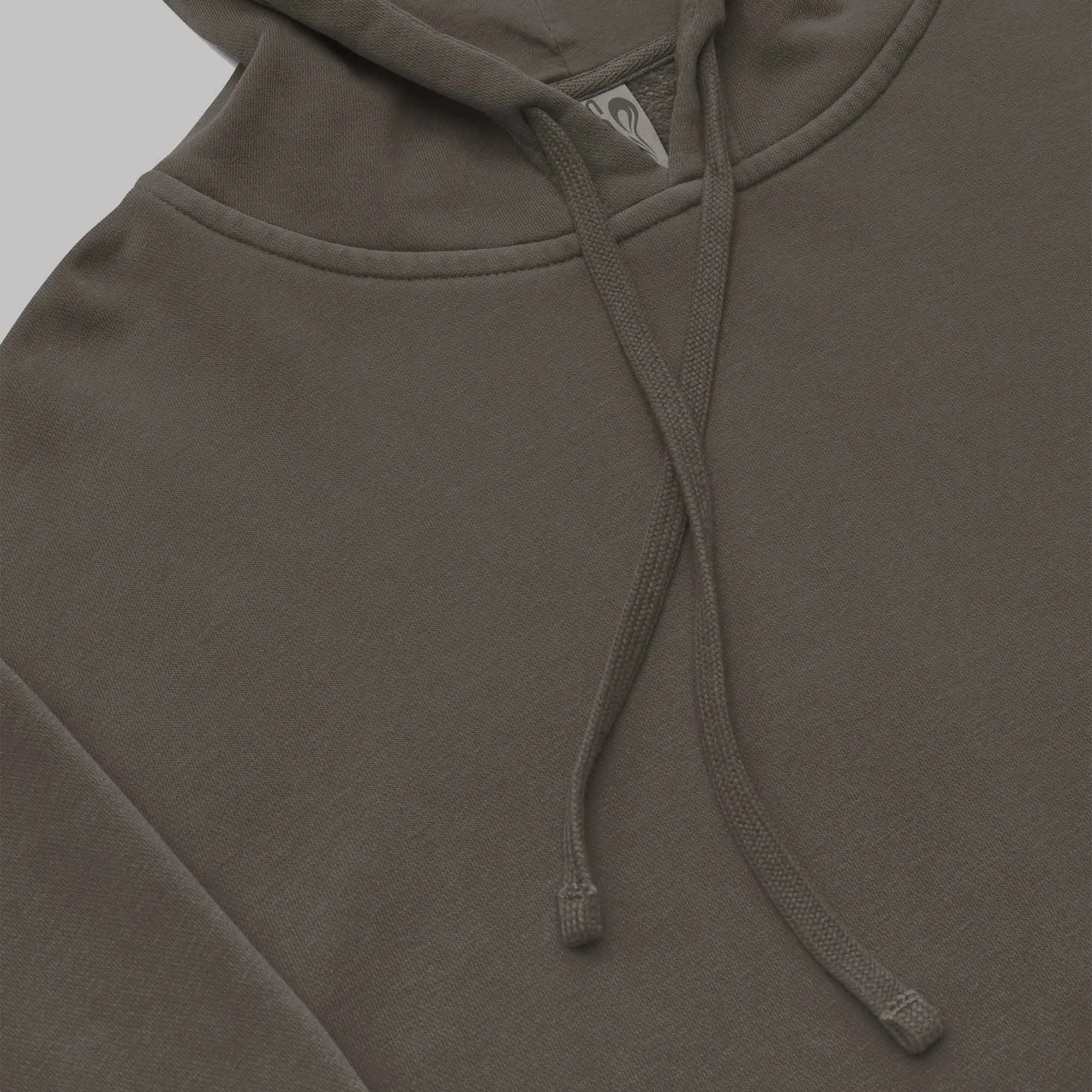 Close-up view of a brown SCSTZ hoodie showing the drawstrings, hood stitching, and soft premium fabric texture.