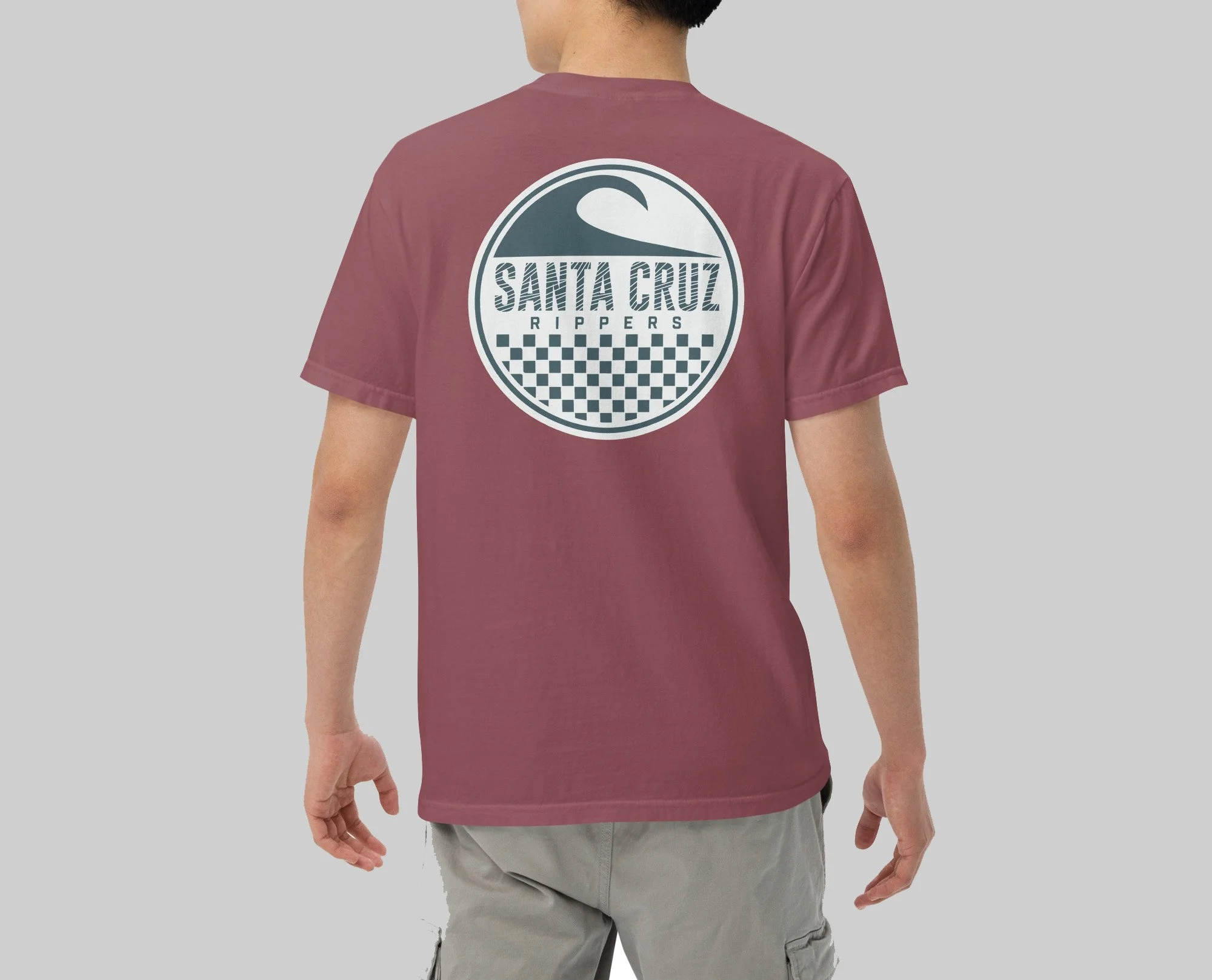 Back of a person wearing a maroon t-shirt featuring a circular logo with a wave, checkered pattern, and the text 'Santa Cruz Rippers' on the back.