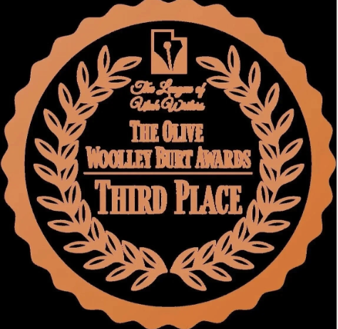 An award badge with a laurel wreath design, featuring text that says "The Olive Woolley Bat Awards Third Place" and an olive branch icon at the top.