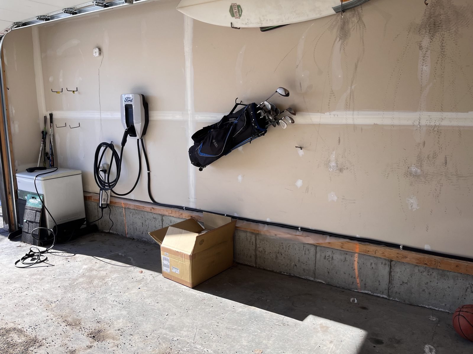 Ford EV charger mounted on a garage wall in Chaparral, Calgary, plugged into a 50 amp receptacle installed by Koop Electrical