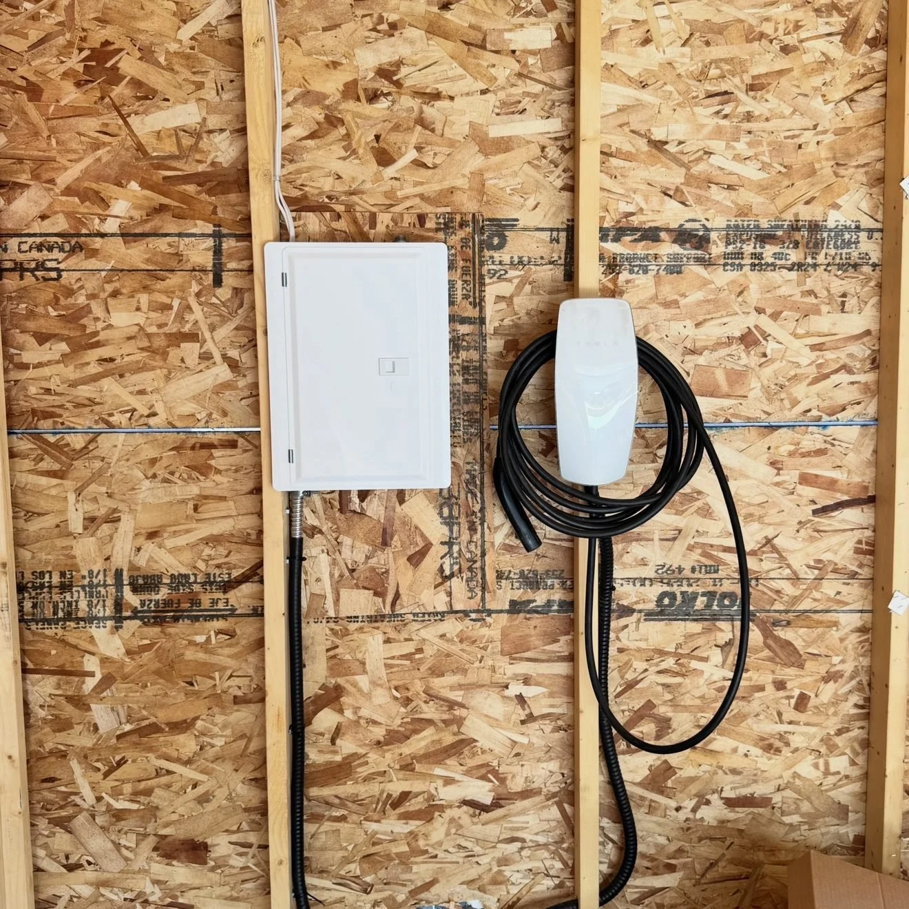 Garage sub-panel and Level 2 EV charger installed by Koop Electrical in Mahogany, Calgary, fed through an energy management system