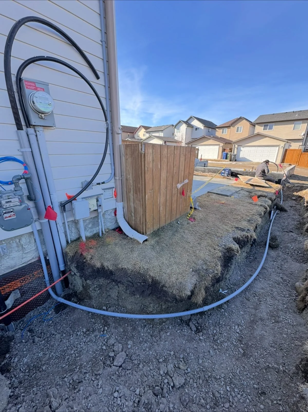 Underground service conduit entering the new meter base at the foundation, part of a new 200 amp service by Koop Electrical in Okotoks