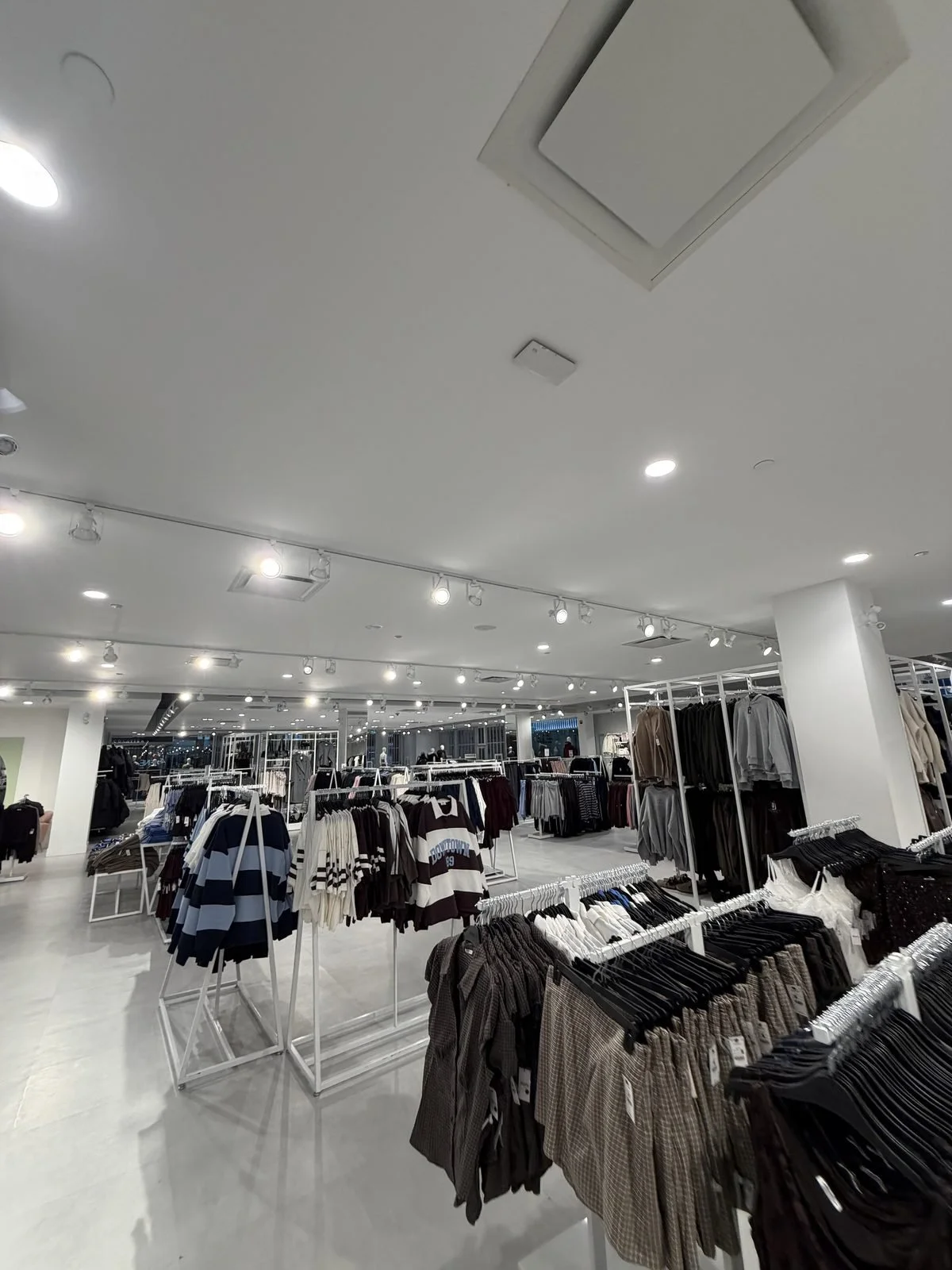 Wide view of the Ardene sales floor in Calgary with all track lighting heads lit after Koop Electrical's retrofit