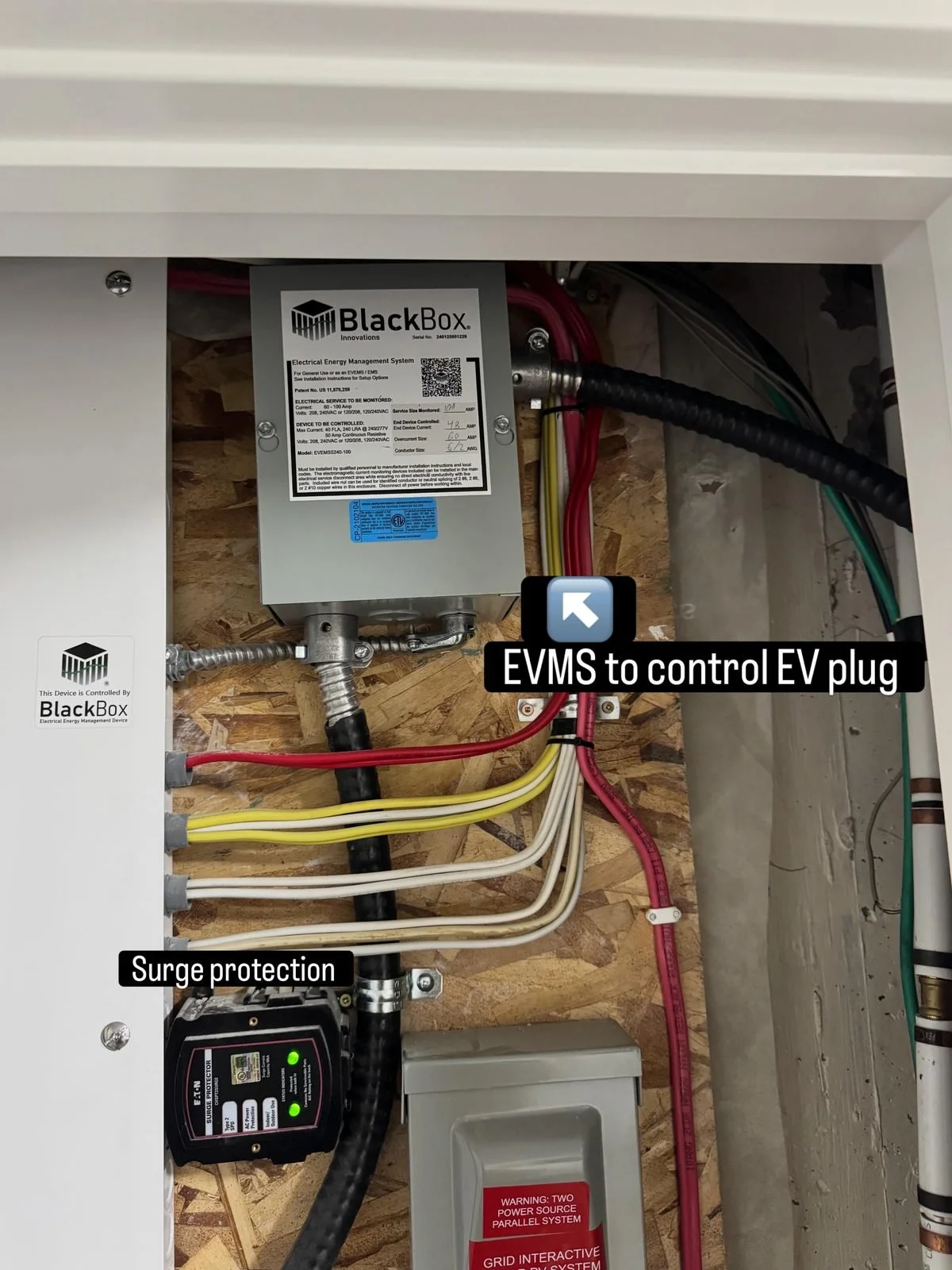 EV energy management system and whole-home surge protector installed by Koop Electrical beside the electrical panel of a Chaparral, Calgary home