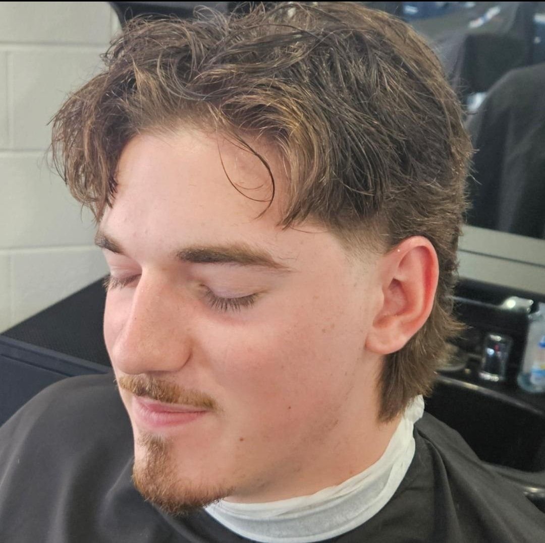 Front view of a men's wavy textured flow hairstyle with a natural tousled finish, styled at Gem City Barbers in Erie, PA.